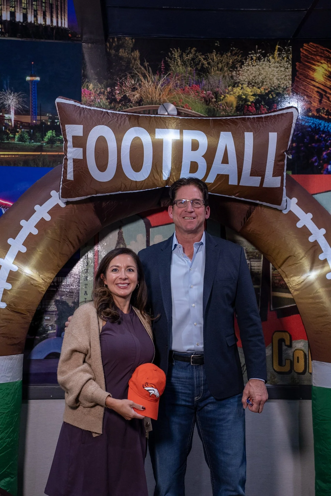 Ed McCaffrey takes a photo with a Denver Football Playbook guest after the live show.