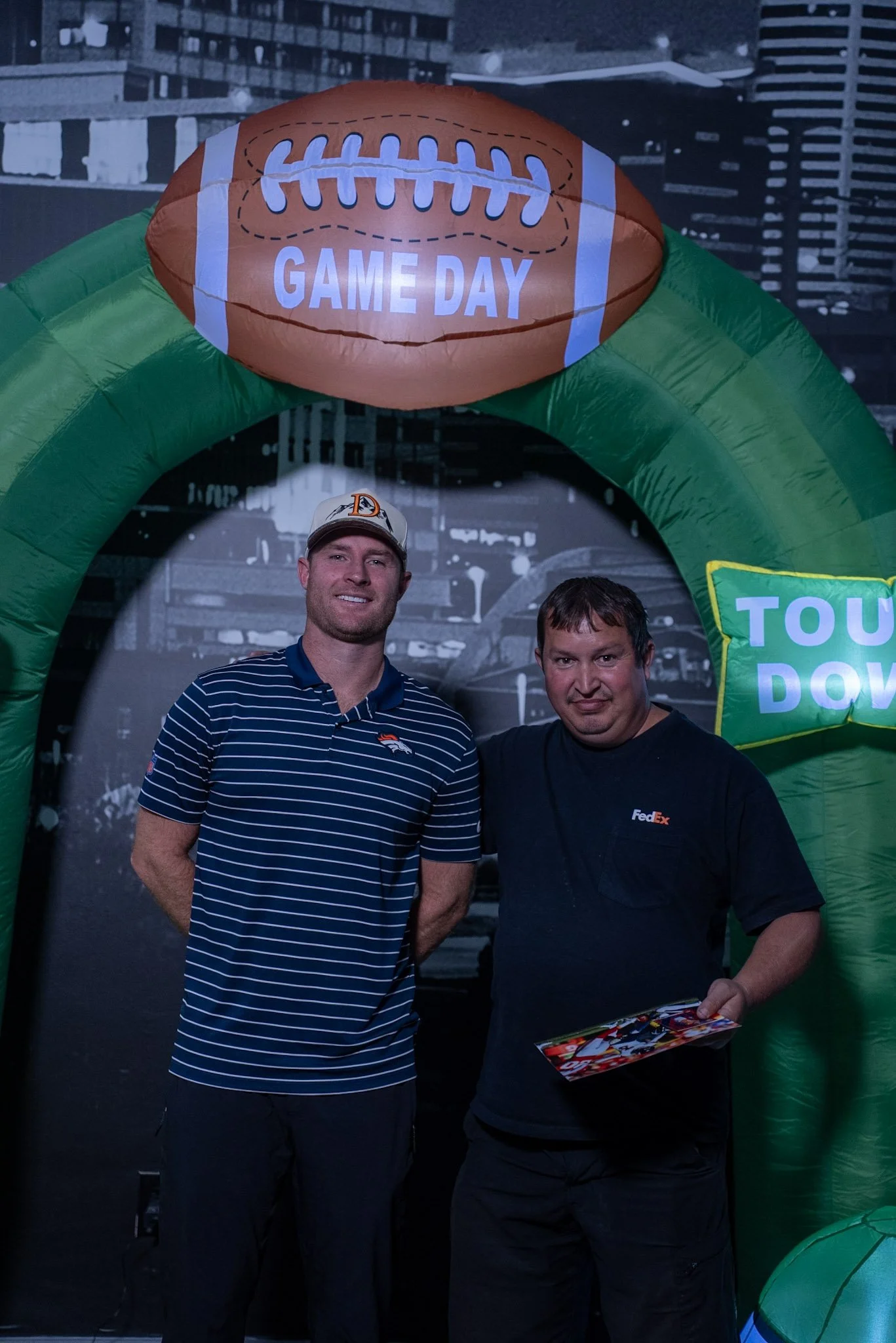 Wil Lutz poses for a photo with a fan at the Denver Football Playbook meet and greet