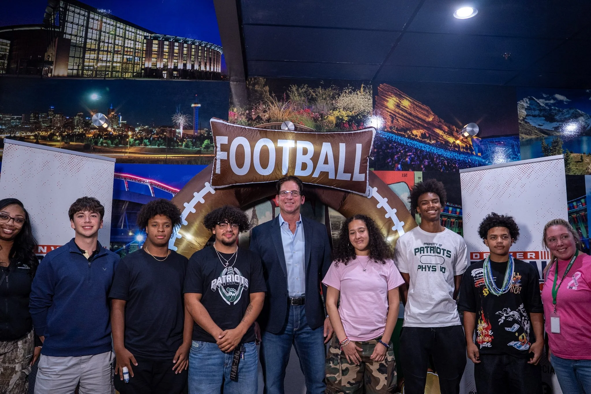 Ed McCaffrey smiles for a group photo with Denver Football Playbook guests.