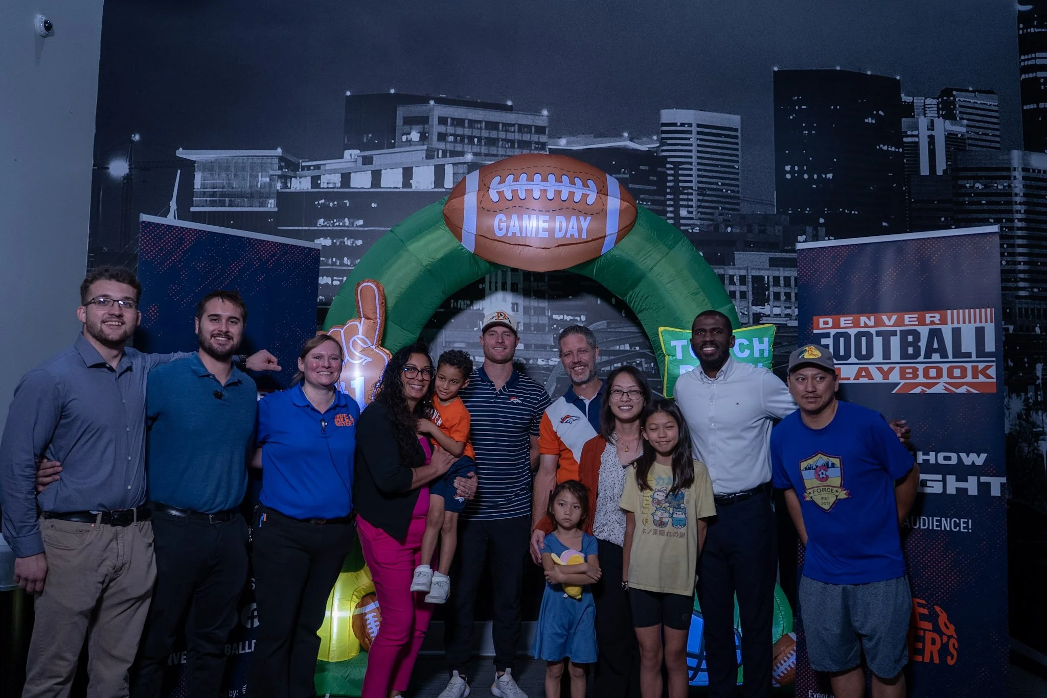  Will Lutz takes a photo with a group of fans after the Denver Football Playbook live show in Westminster, Colorado