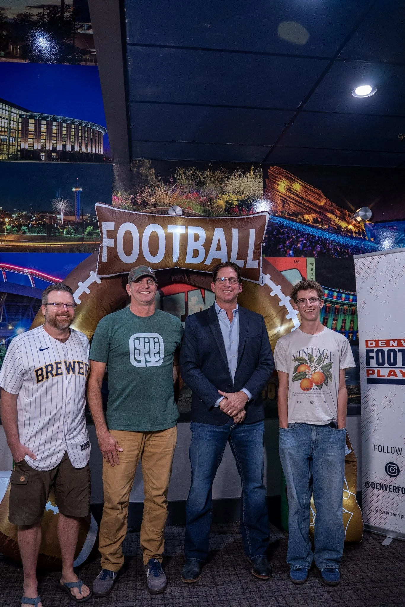 A group of Denver Football Playbook guests meets Ed McCaffrey after the live show.