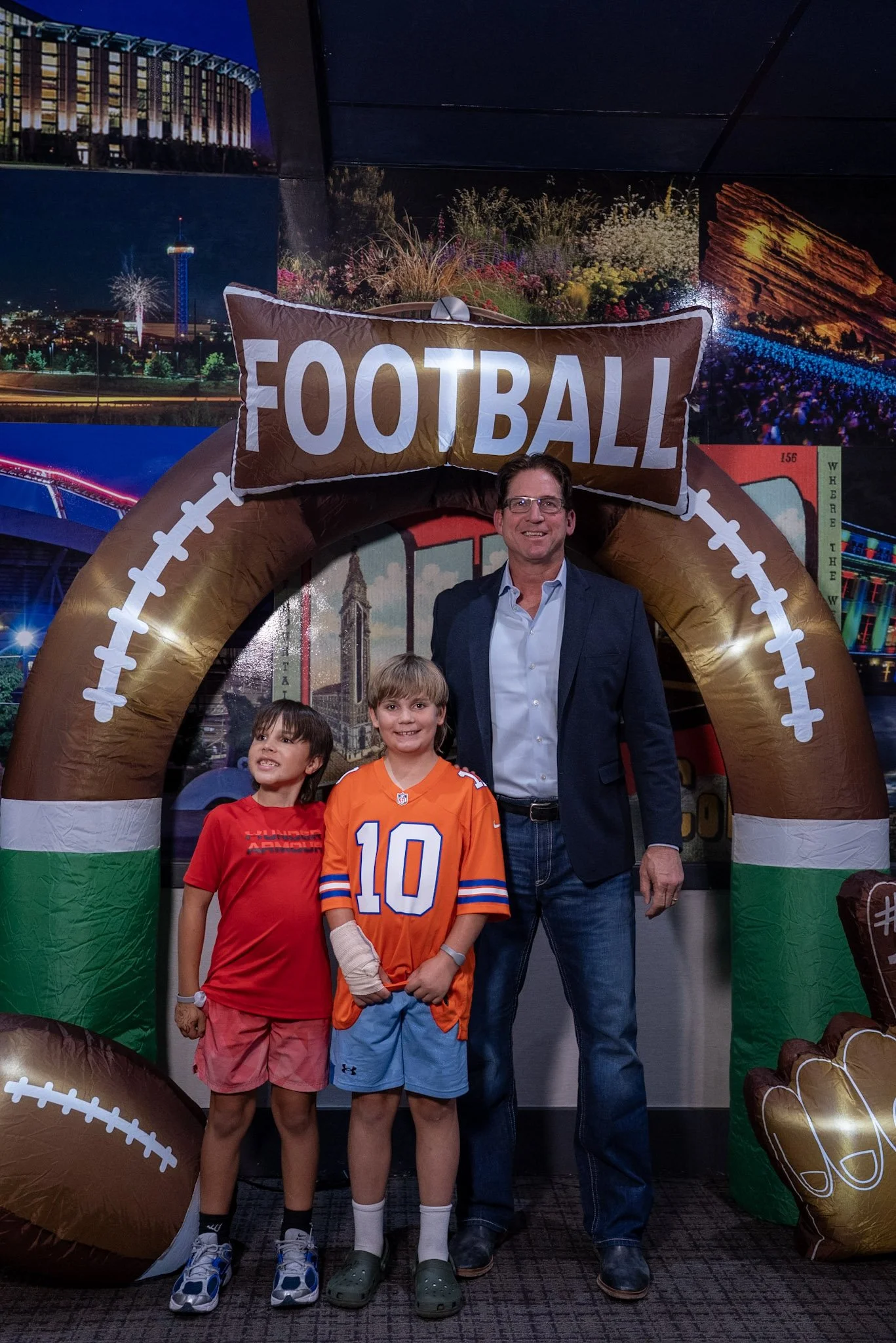 Ed McCaffrey smiles with two kids during the  Denver Football Playbook post-show meet and greet.