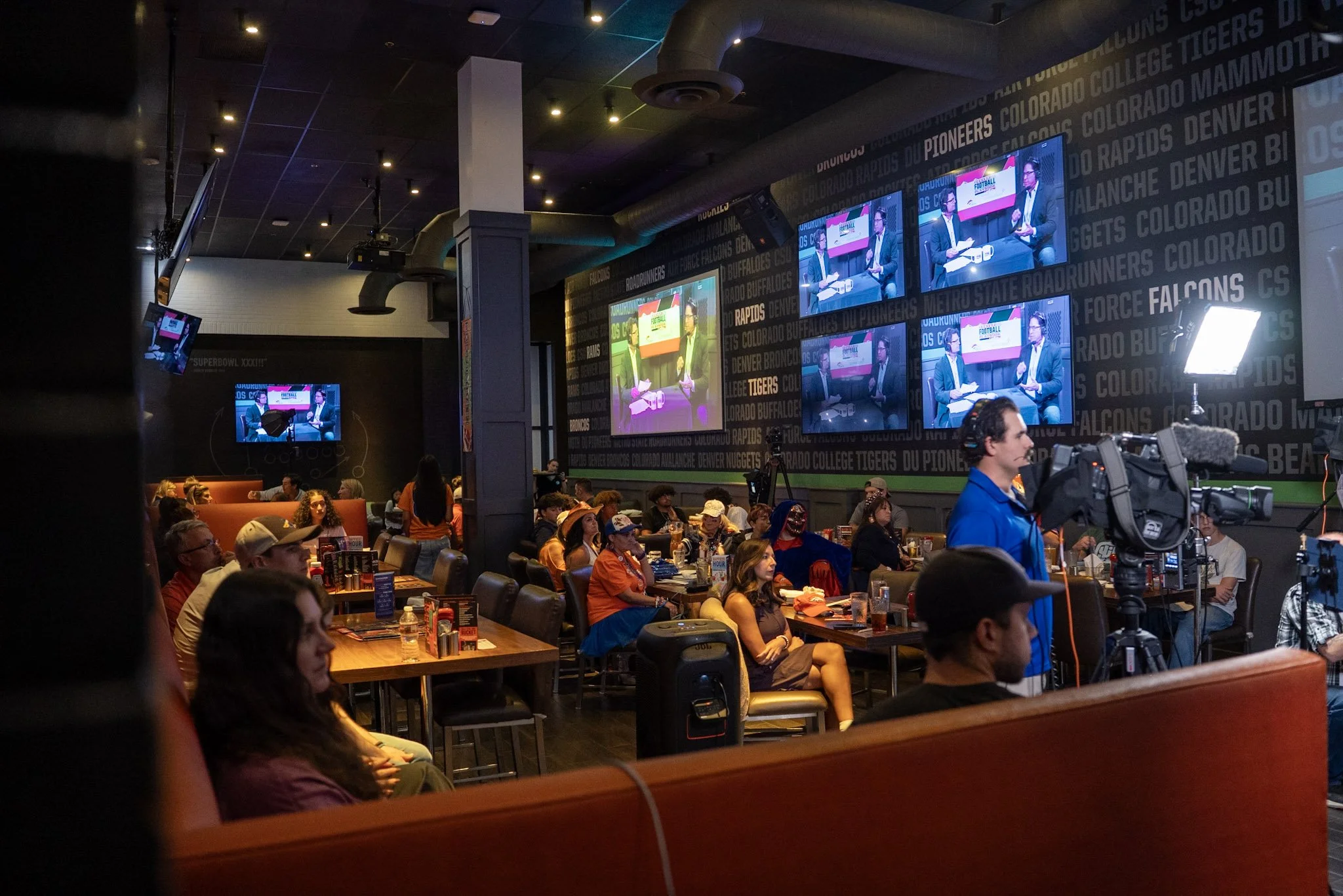 Fans fill the room for a live episode of Denver Football Playbook featuring Ed McCaffrey.