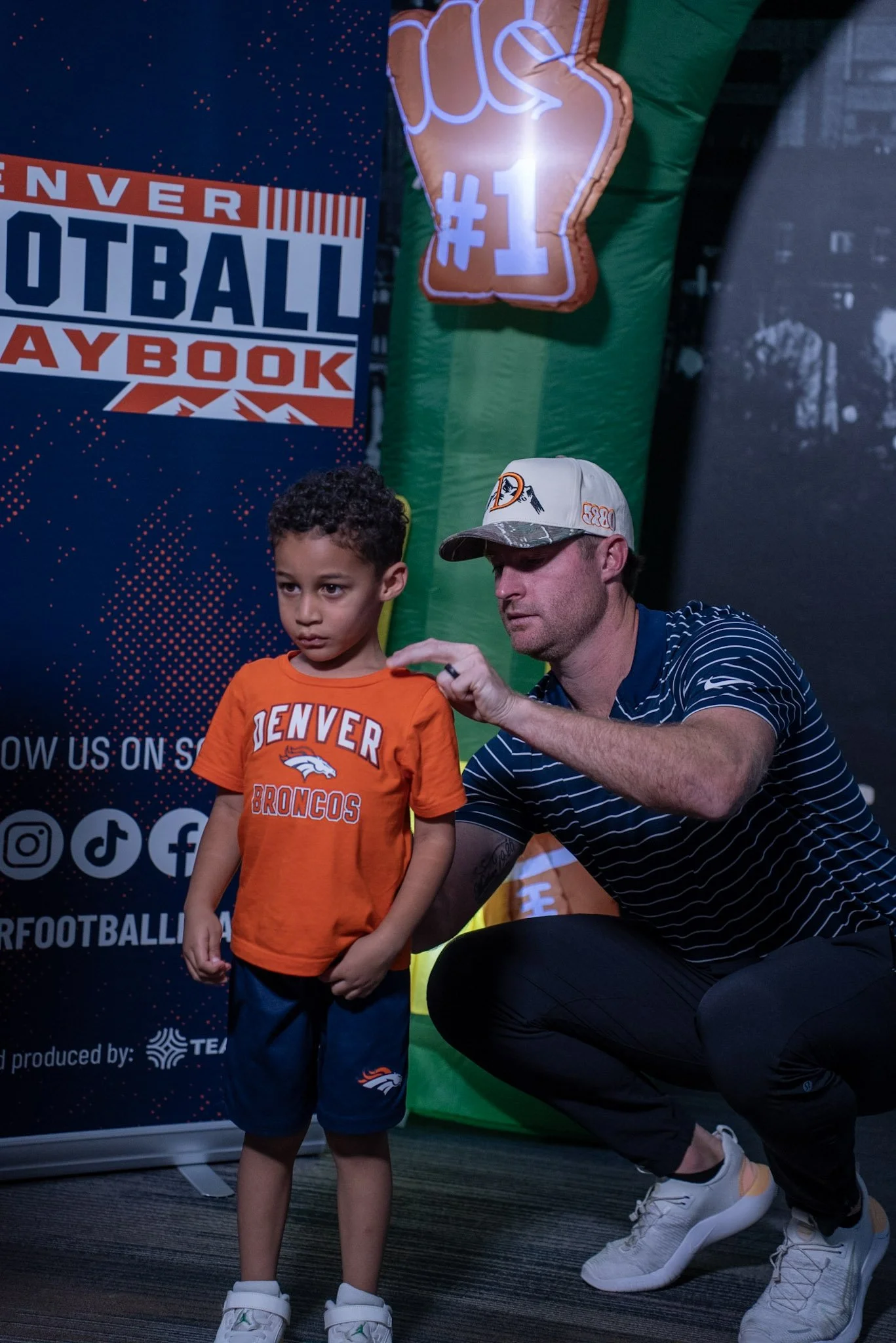Denver Football Playbook Season 1 Episode 1 Wil Lutz signing the back of a kid's shirt at Dave & Busters - Westminster