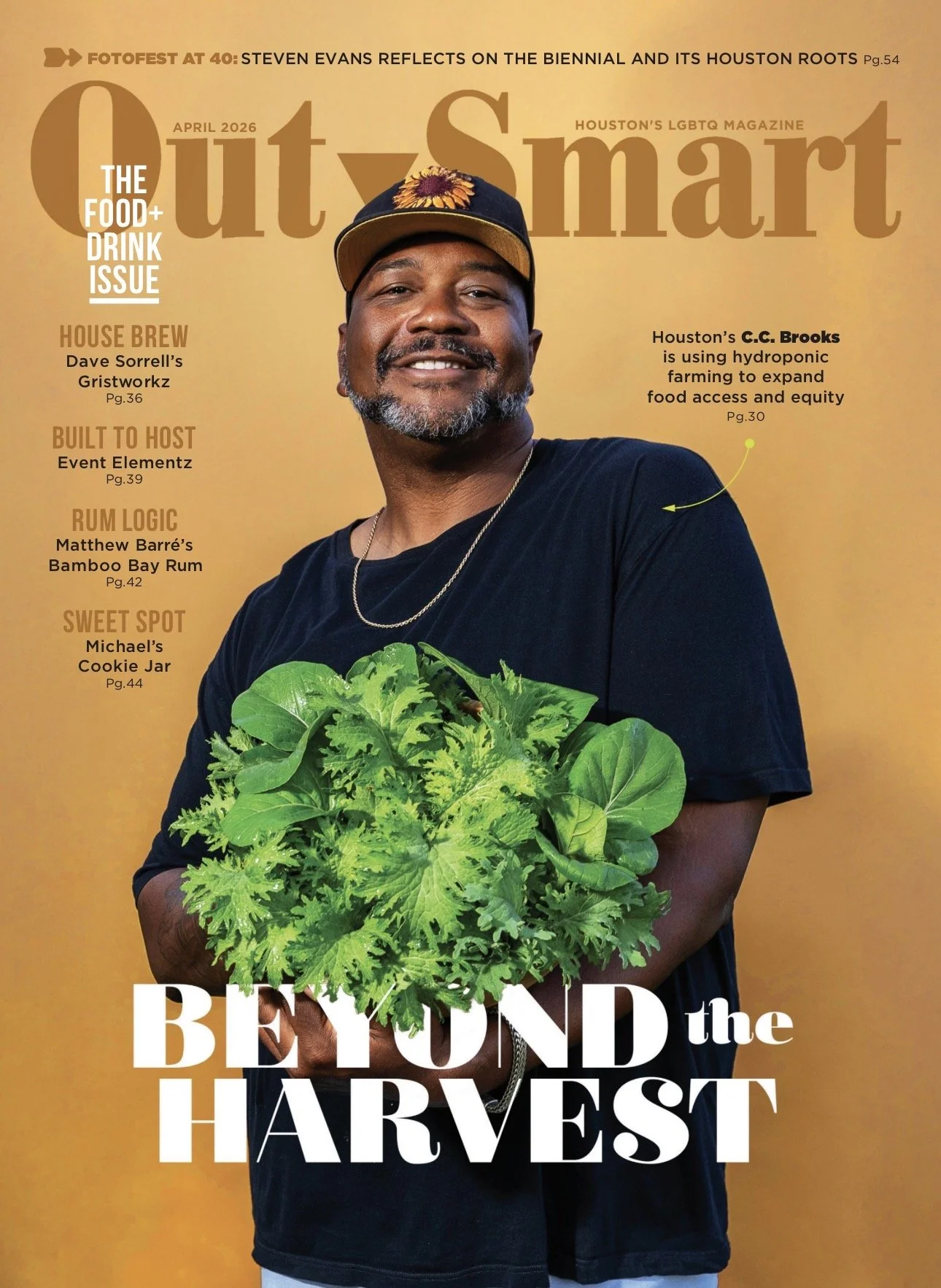 Magazine cover featuring a smiling man holding a bunch of fresh green leafy vegetables, wearing a black t-shirt, gold chain, and a cap with a sunflower design. The text includes headlines about food, drink, hydroponic farming, and local events, with the main headline reading "Beyond the Harvest."
