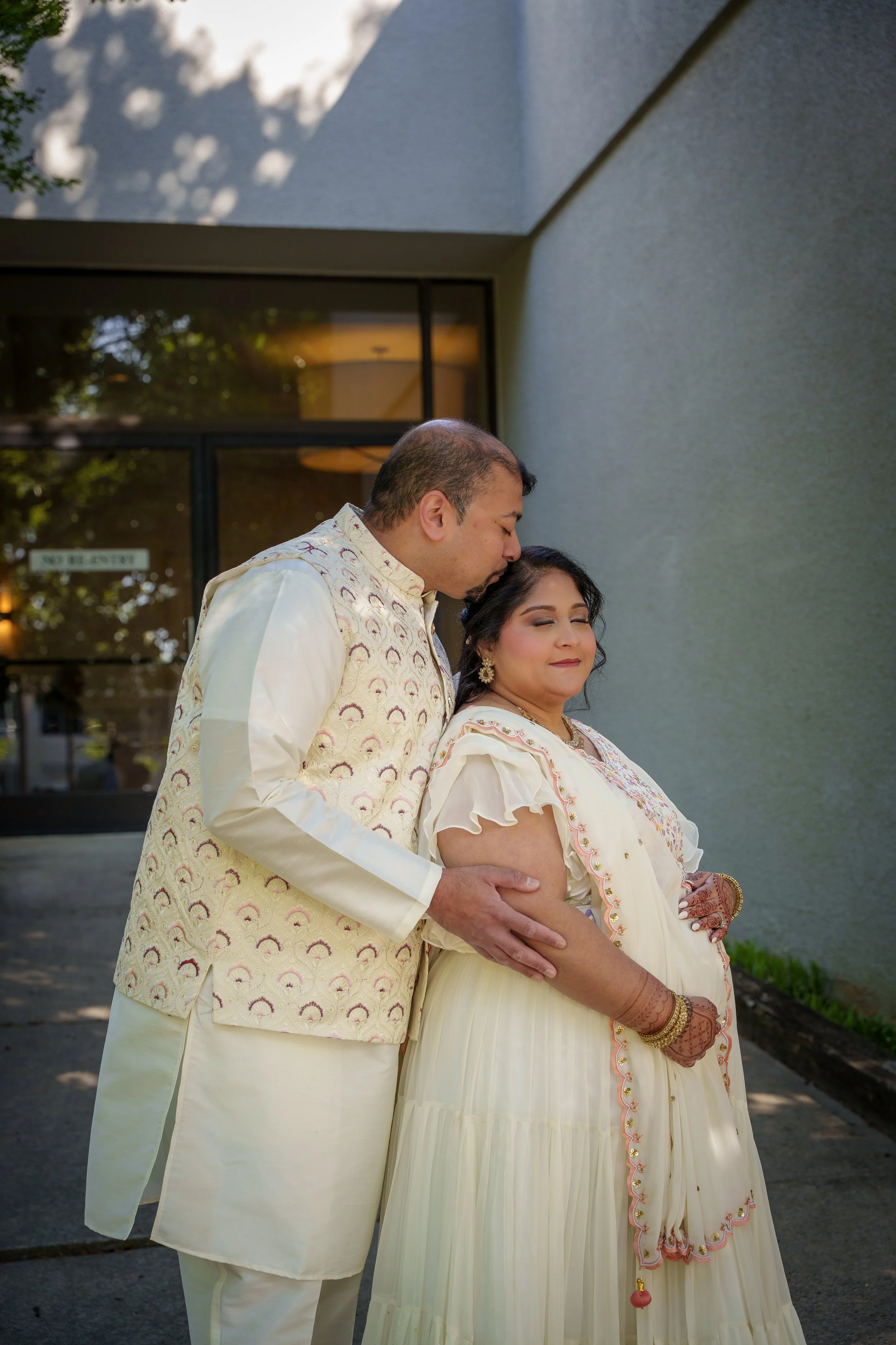 Husband kissing his wife's forehead, both in cream, couples photographer Fort Mill SC