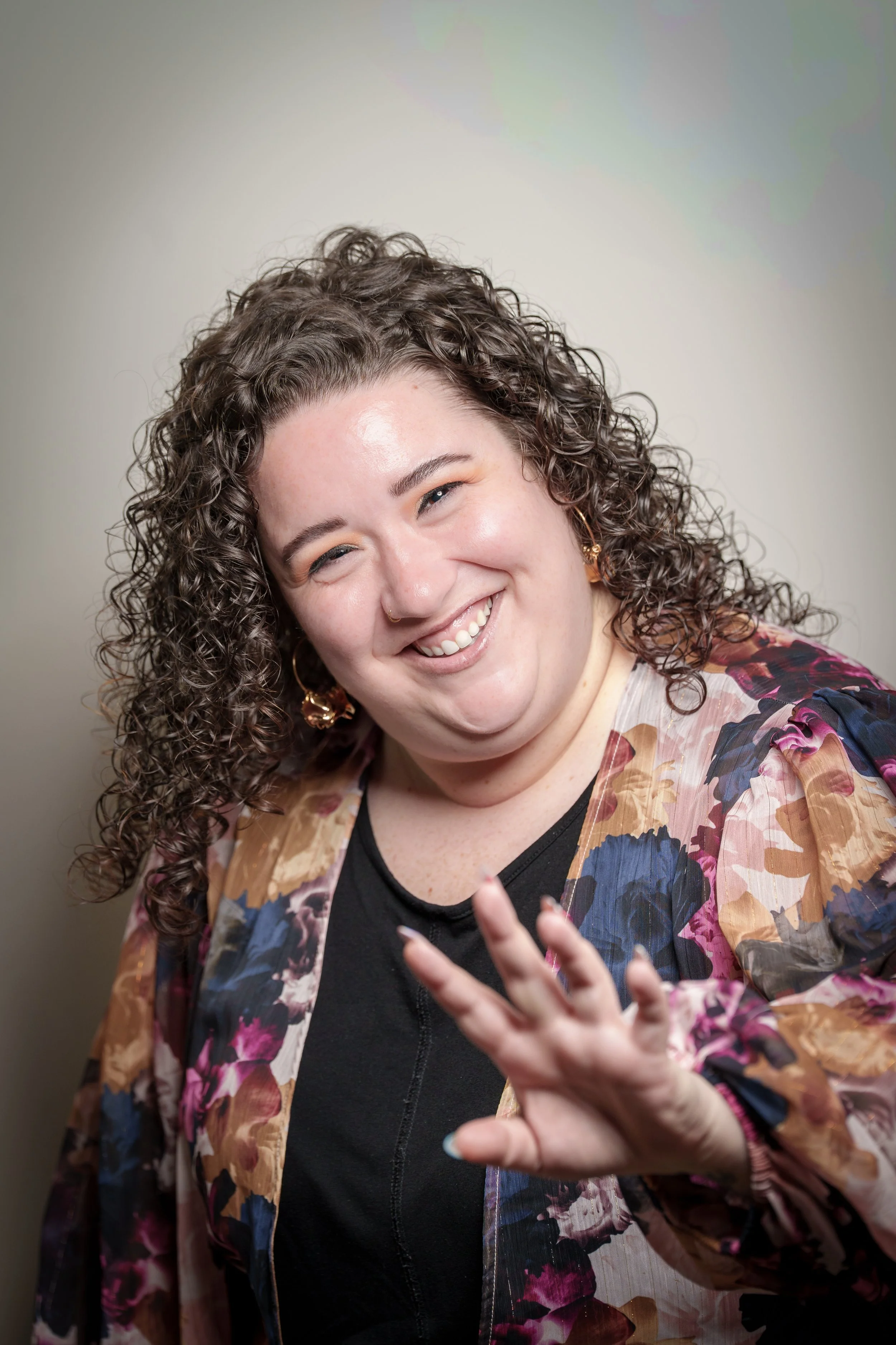 Woman in a floral kimono laughing with her hand outstretched, natural light portrait photographer Fort Mill