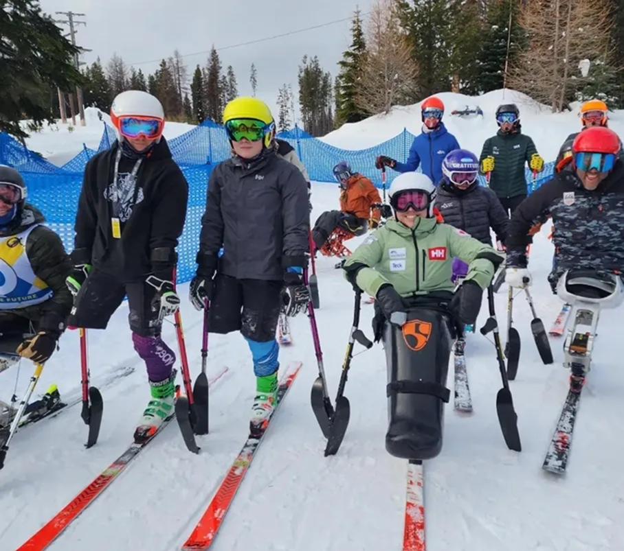 Group of adaptive skiers gathered together on a snowy mountain.