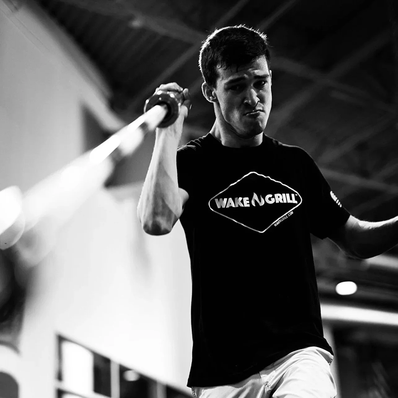 Para-athlete training with a resistance band in a gym.