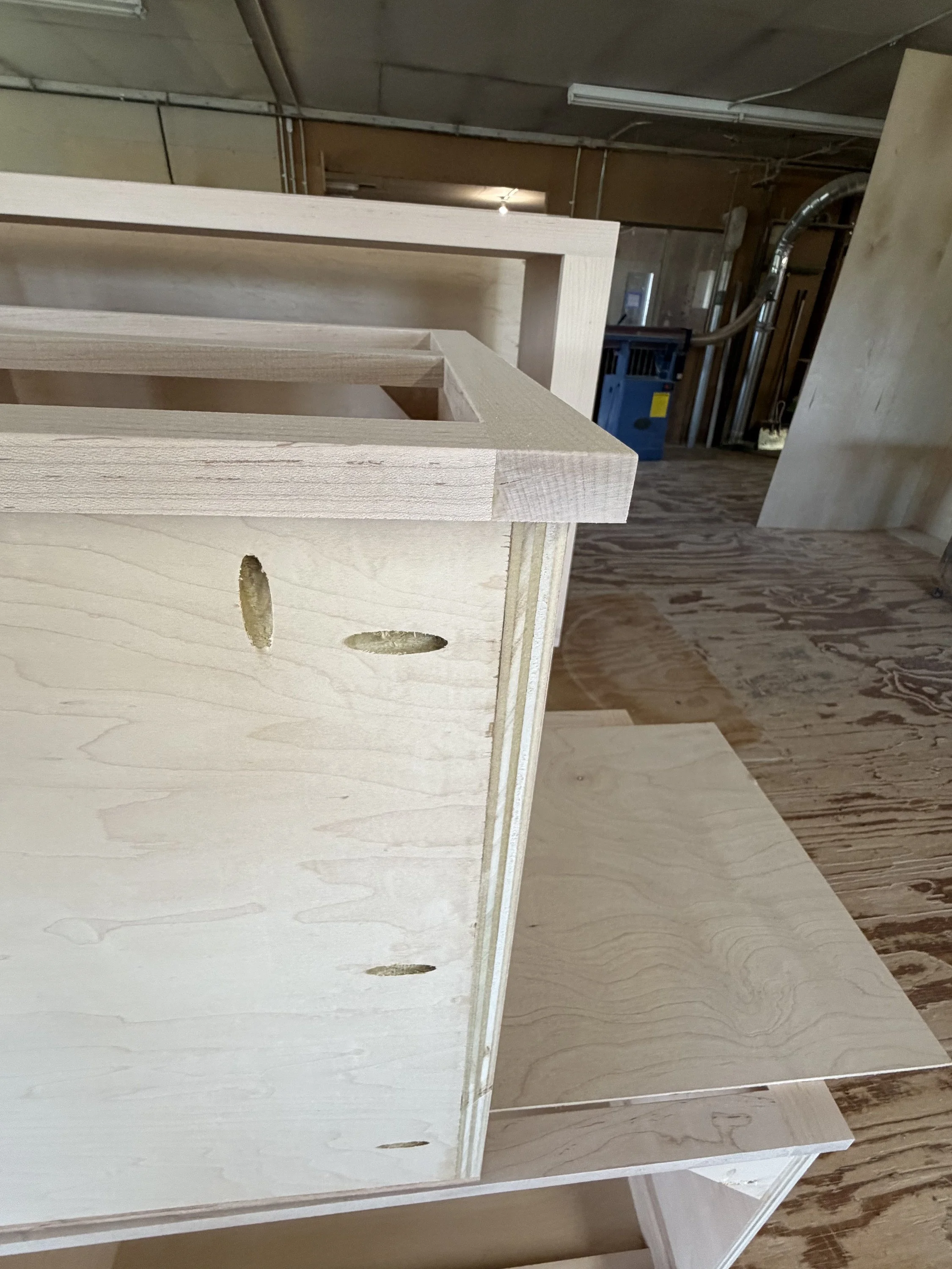 Unfinished cabinet box showing plywood construction and pocket-hole joinery