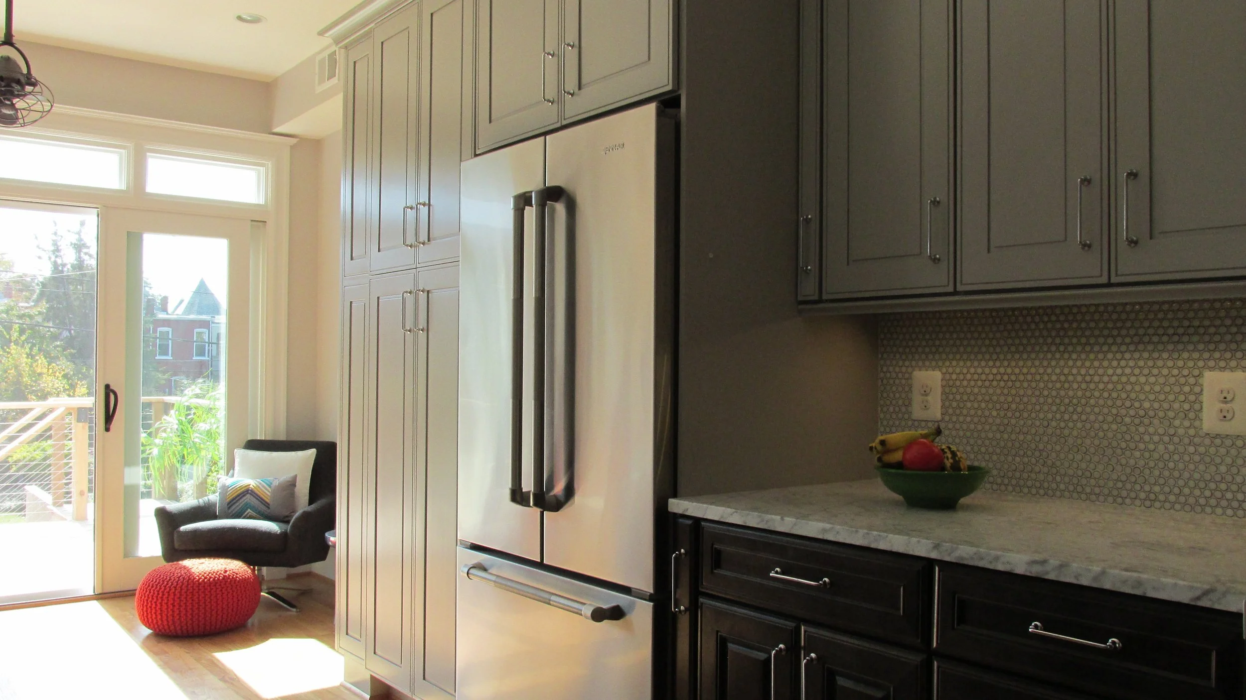 Tall run of sage-painted cabinets with a panel-ready refrigerator set flush into the cabinetry