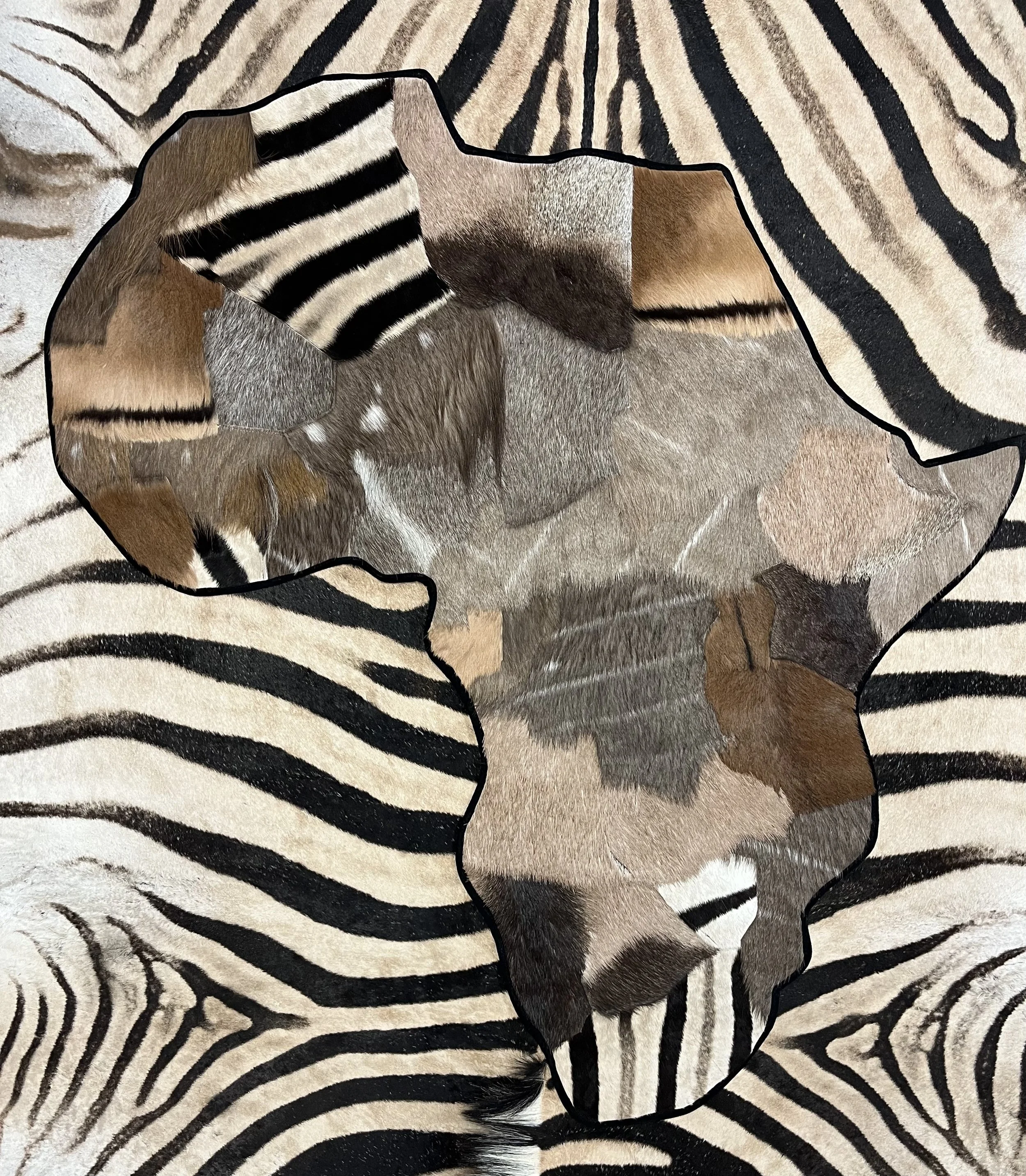 A collage of animal fur patterns including zebra stripes, tiger stripes, and giraffe spots.