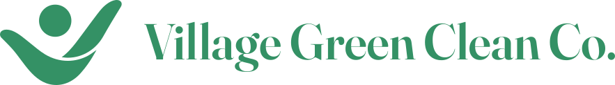Logo of Village Green Clean Co., featuring a green abstract figure with a smile, and the company name in green text.