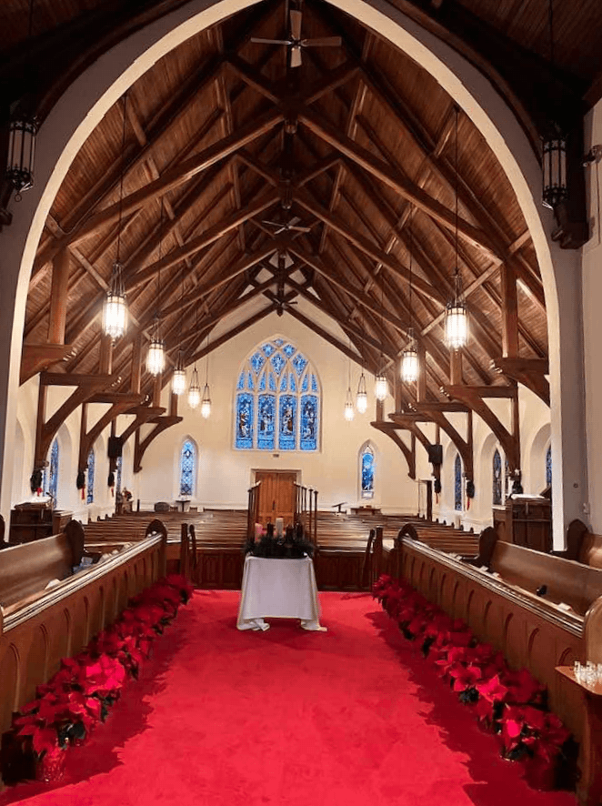 Interior of St. Mark’s Episcopal Church in Newark, New York, showing the wooden Gothic Revival roof, nave, and stained-glass windows.