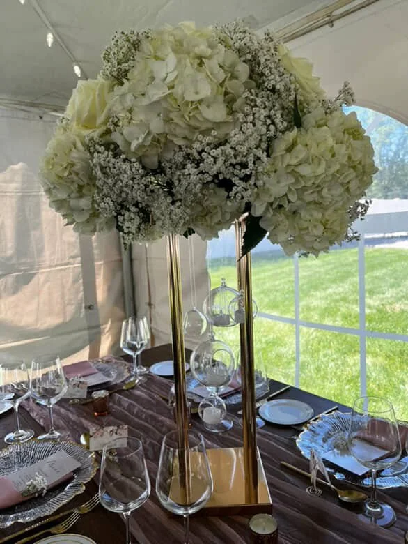 tall white flowers on table at an event.JPG