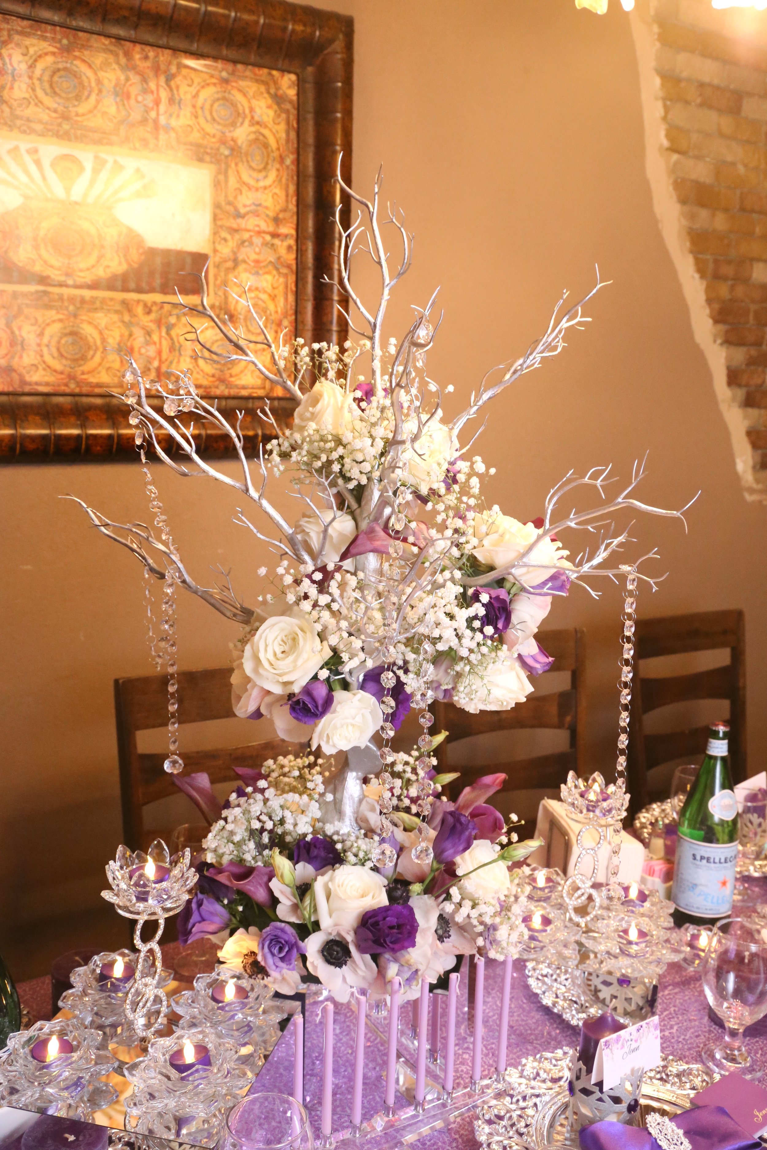 purple and white centerpiece on a table