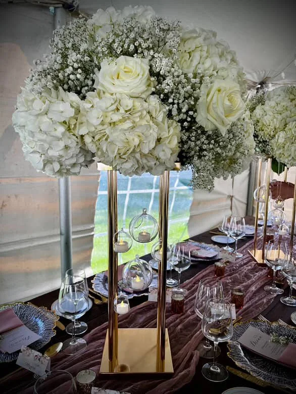 table setting at an event with tall white flowers.JPG