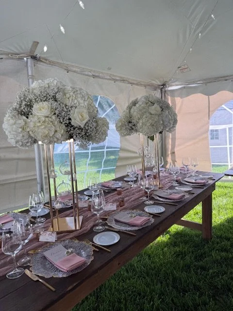 table scape with white flowers under a tent.JPG