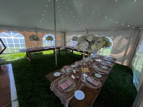 pink and white table settings at event under tent.JPG