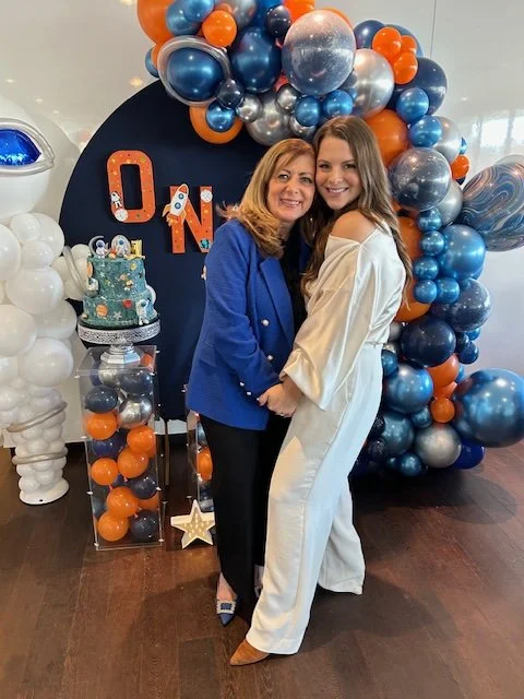 clara with client and balloon arch.JPG