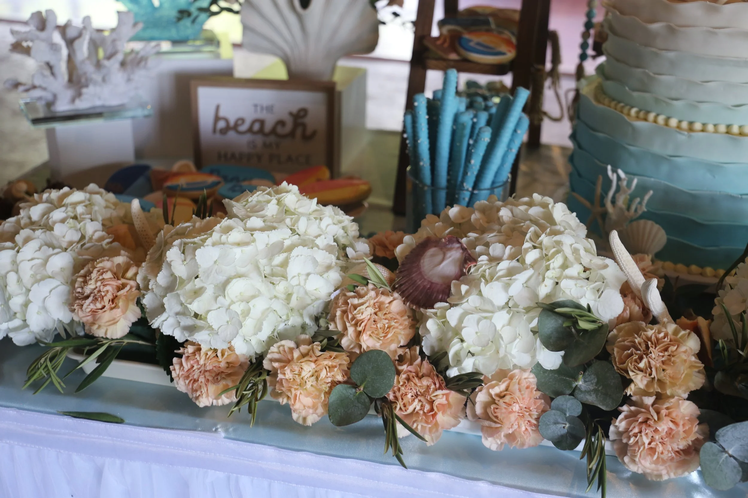 coastal themed cake with white floweres.JPG