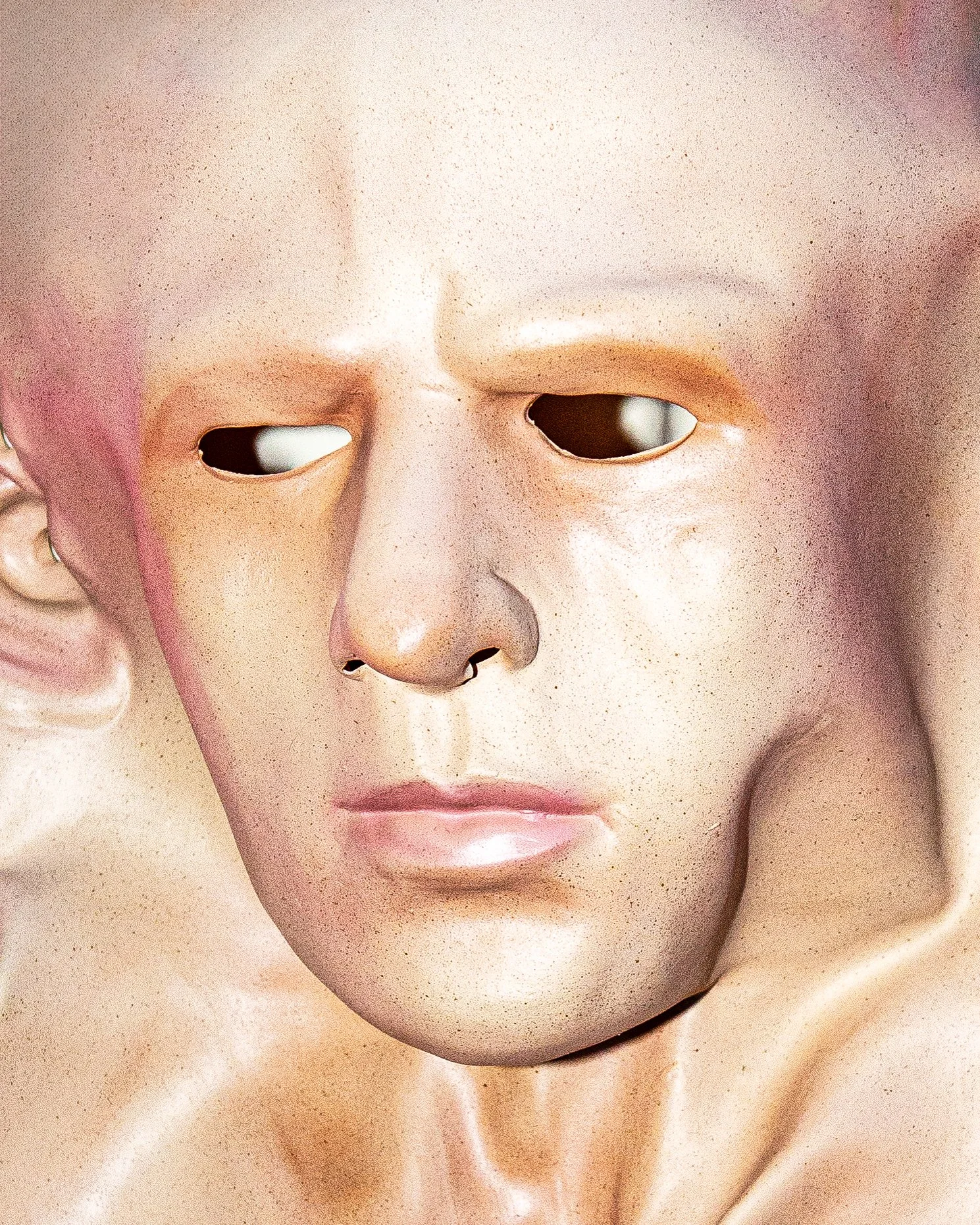 Close-up of a doll's face with a slightly open mouth, closed eyes, and a smooth, waxy complexion.