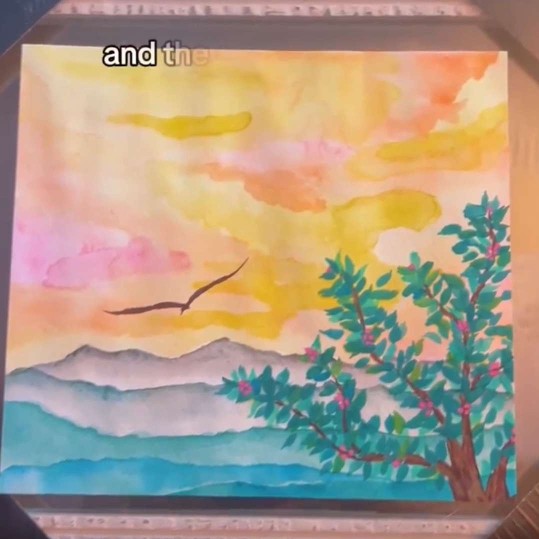 Image of a LinkedIn post of a freshly completed watercolor painting of whimsical mountains and a bird flying overhead with rhododendrons, part of the Roan Mountain Collection.