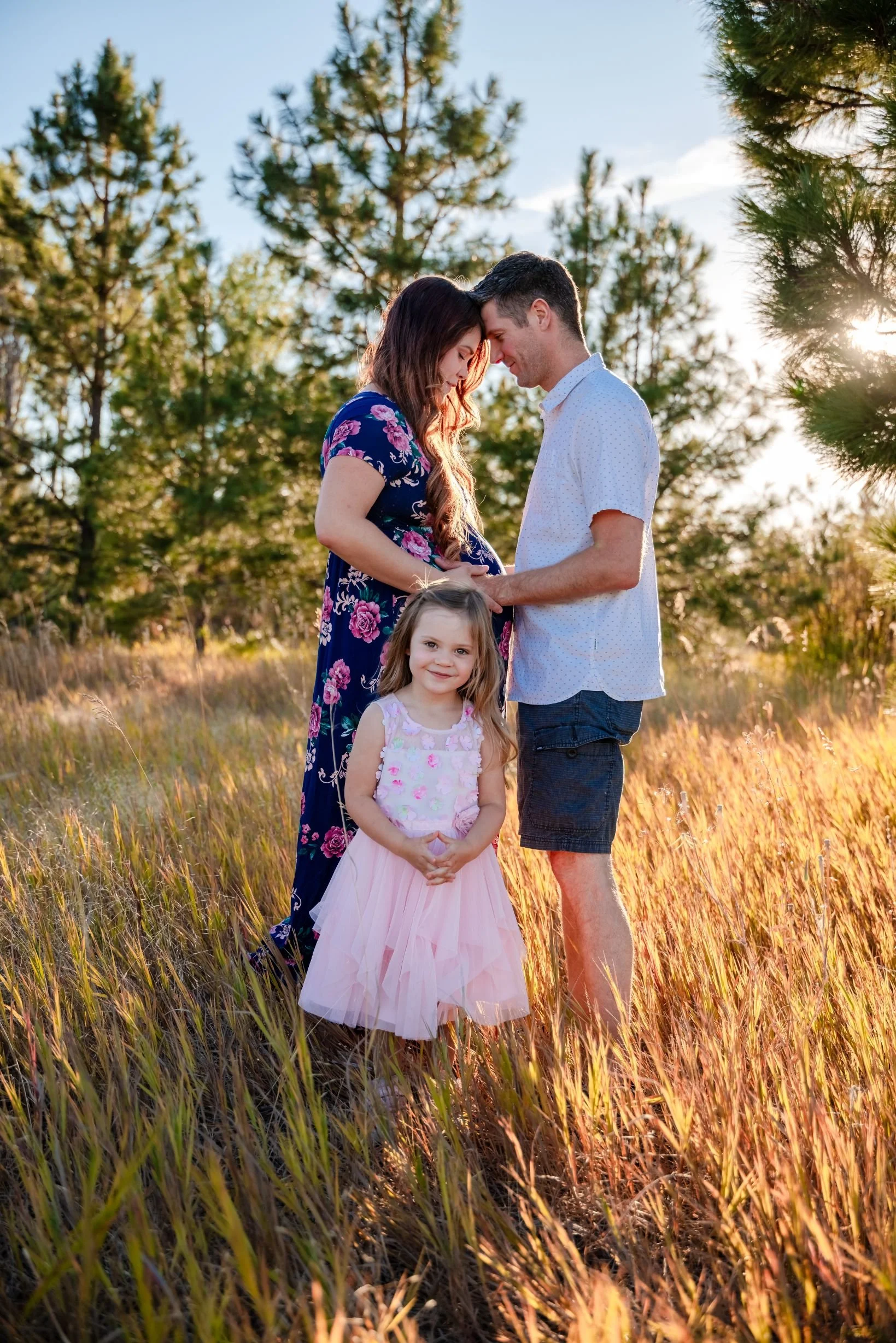 family maternity portrait at in forest at sunset