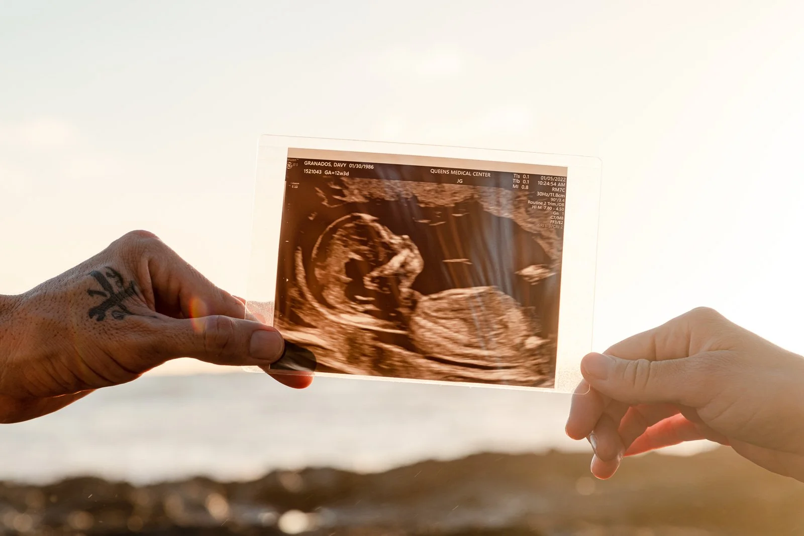 baby sonogram photo mom dad hands portrait