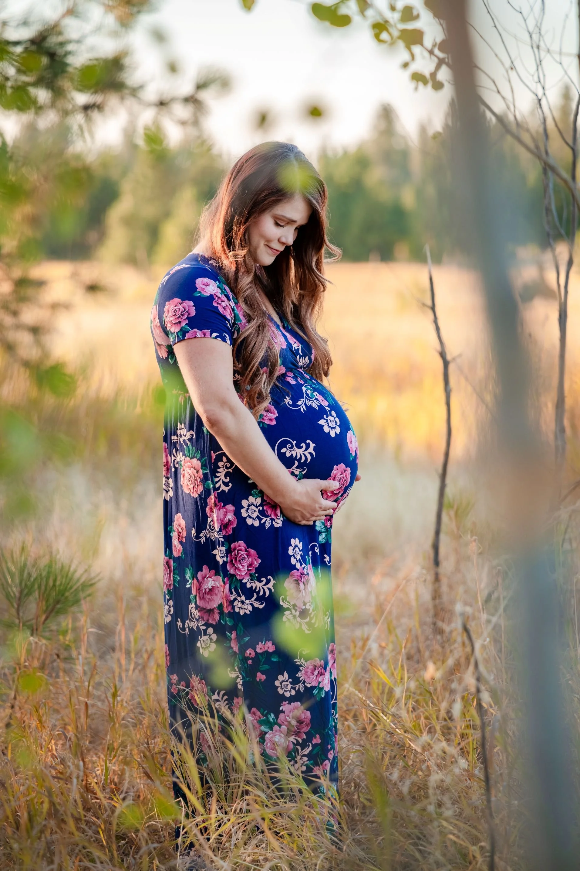 woman's maternity portrait in meadow