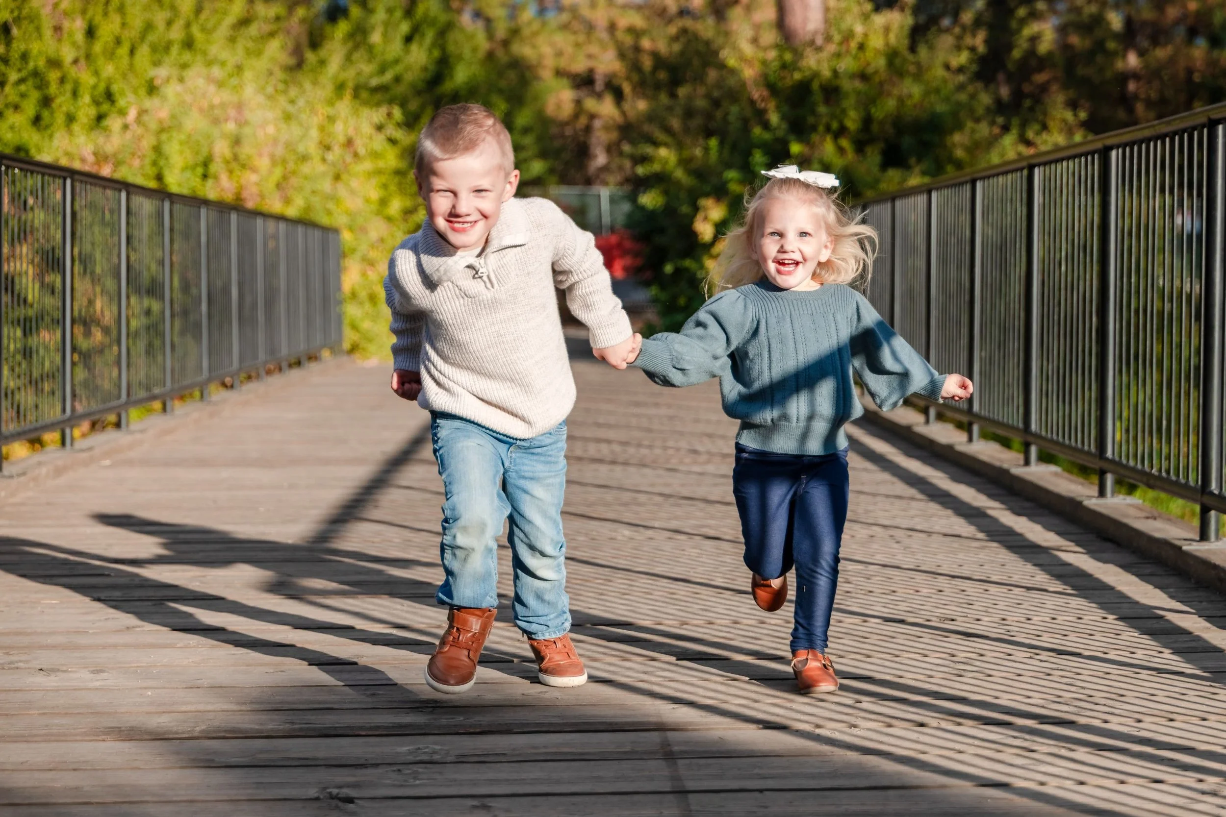 spokane kids running on park bridge