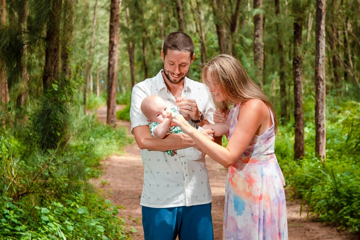 couple with newborn baby in forest coeur d'alene