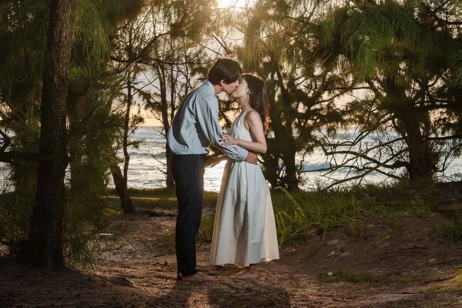 boy kissing in forest girl couples engagement