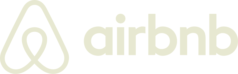 Airbnb logo in light beige color on a white background.