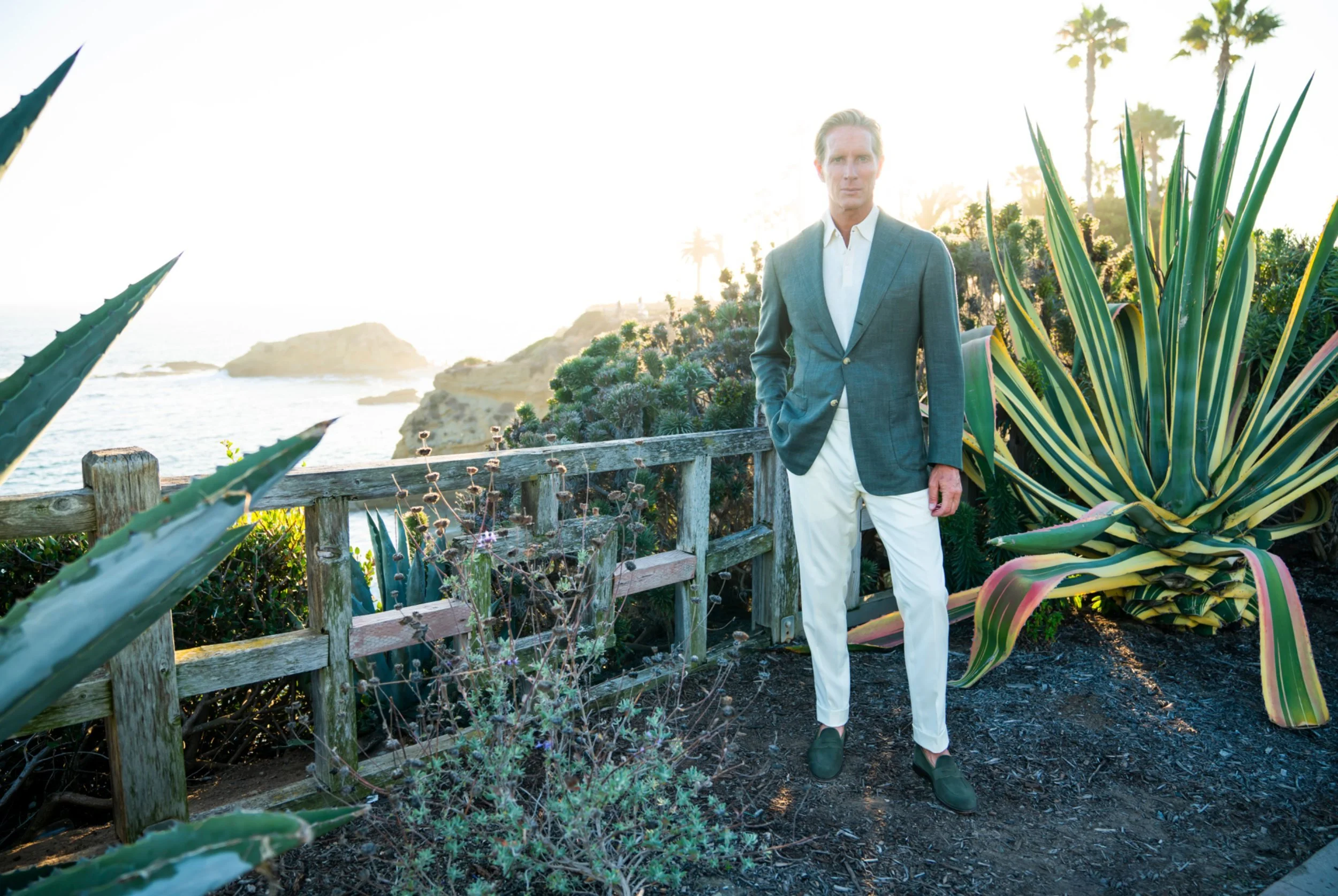 Christian Gardner in a Scarborough custom sport coat and cream trousers on the coastal bluffs in Laguna Beach.