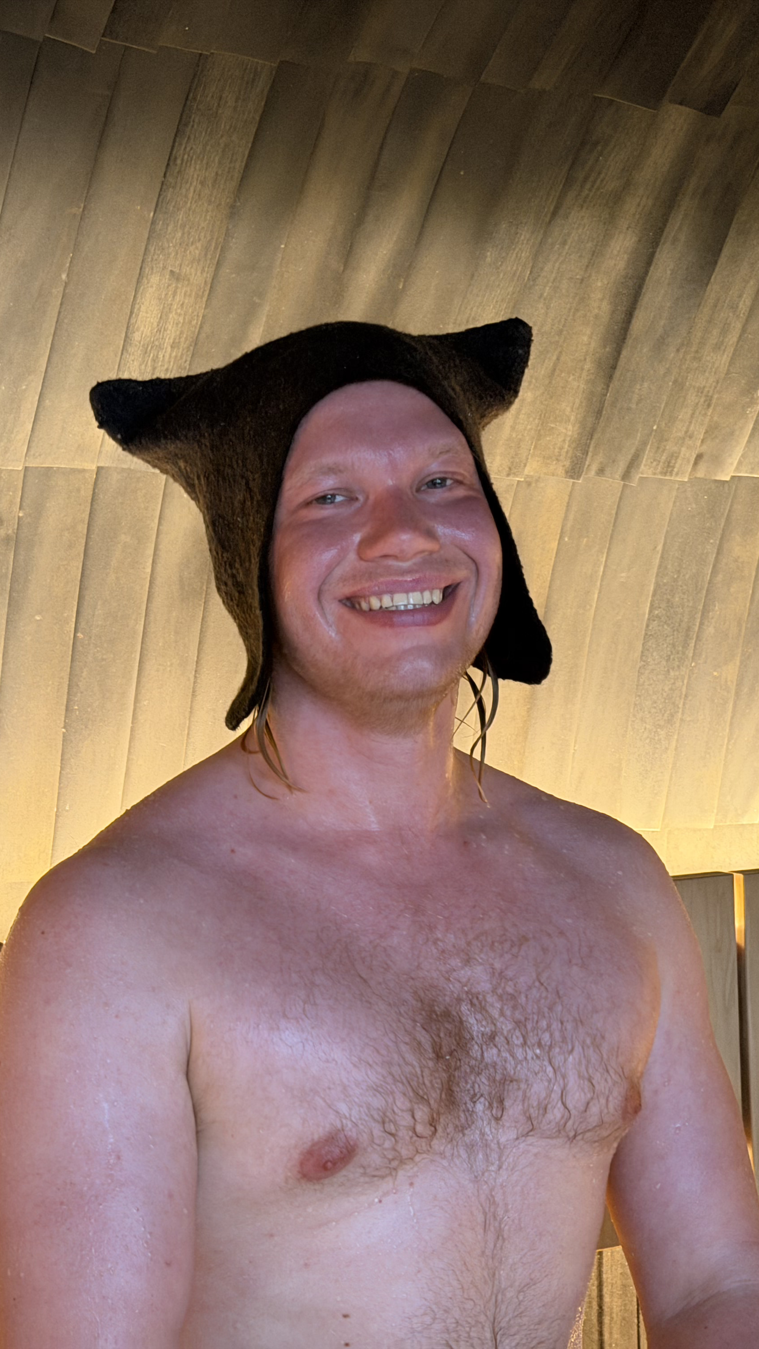 Aleksi in sauna with a hat.png