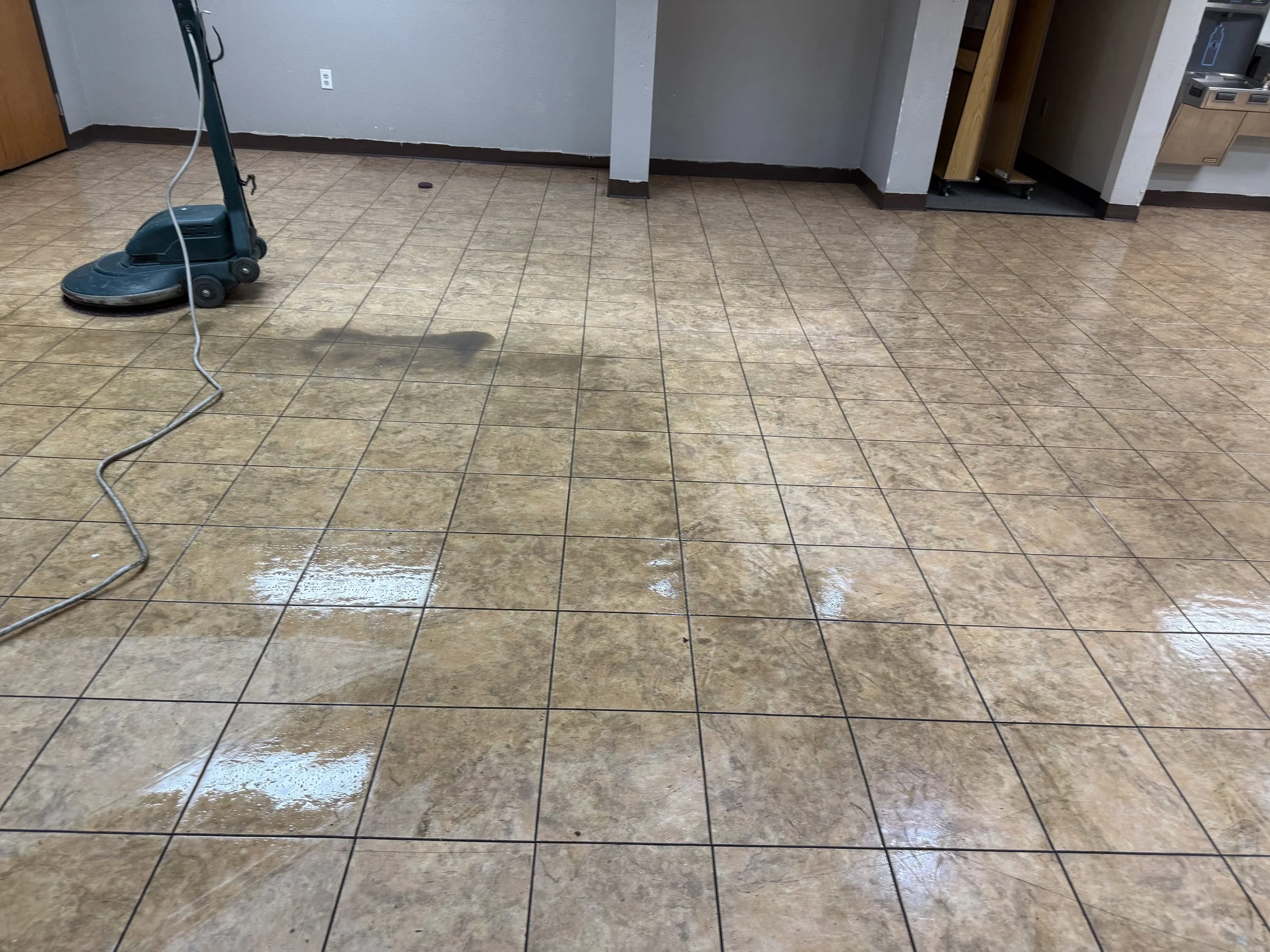 "Commercial tile and grout cleaning machine restoring a shiny tile floor in Arlington, Texas."