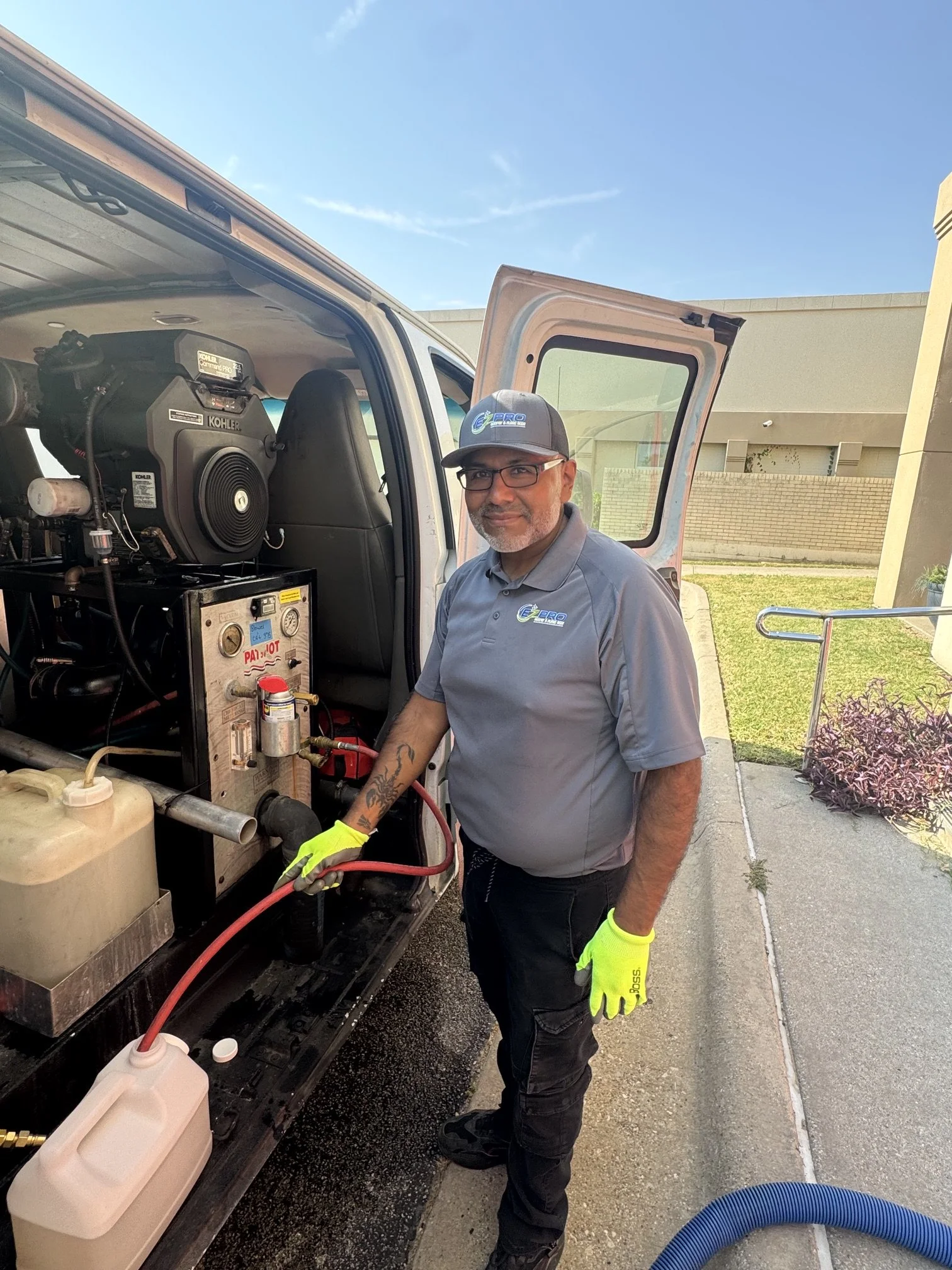 "EZ PRO carpet cleaning technician preparing commercial equipment inside a service van in Arlington, TX."