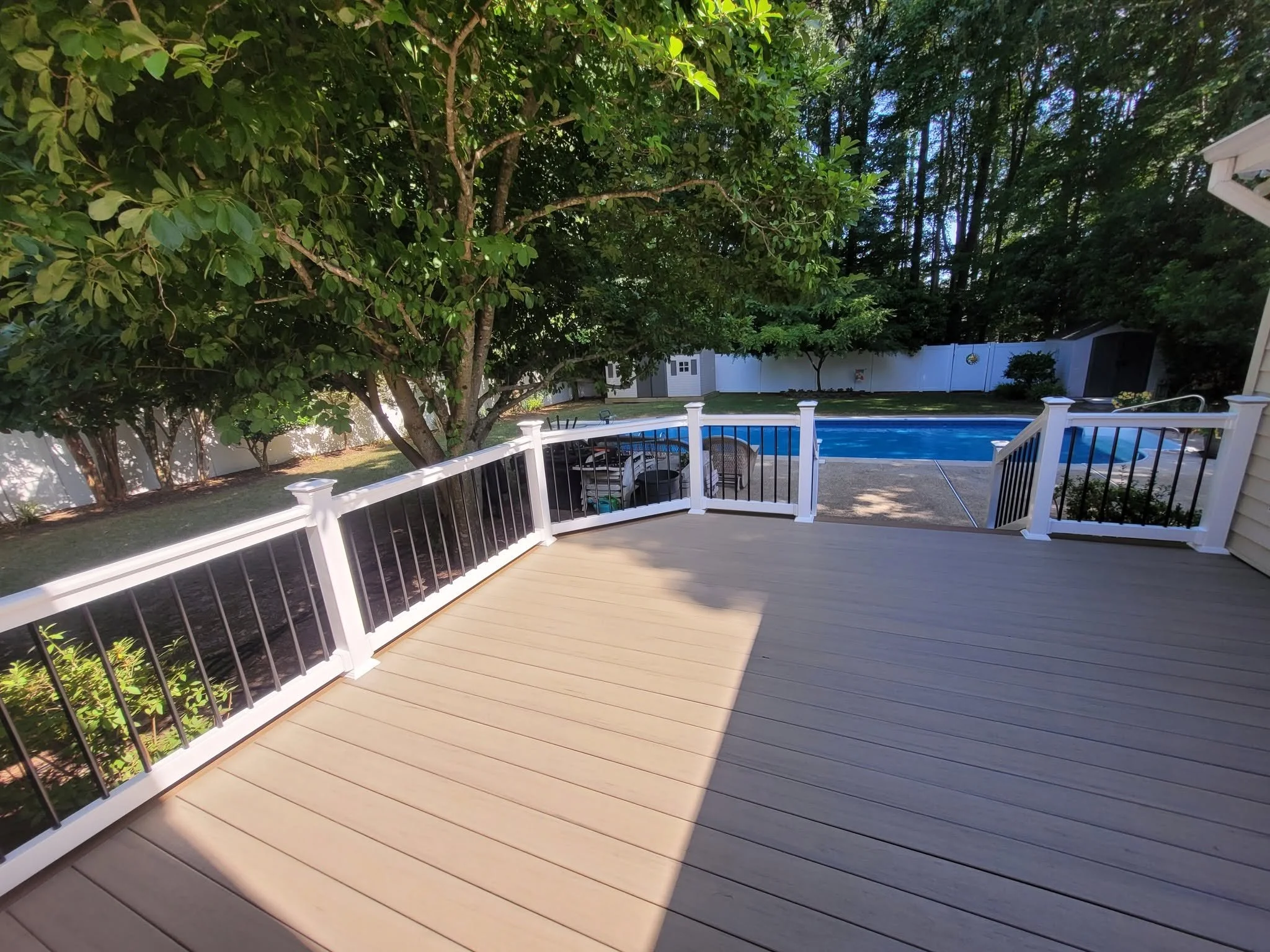 Composite Deck w/ White Vinyl railing w/ Black Aluminum Balusters