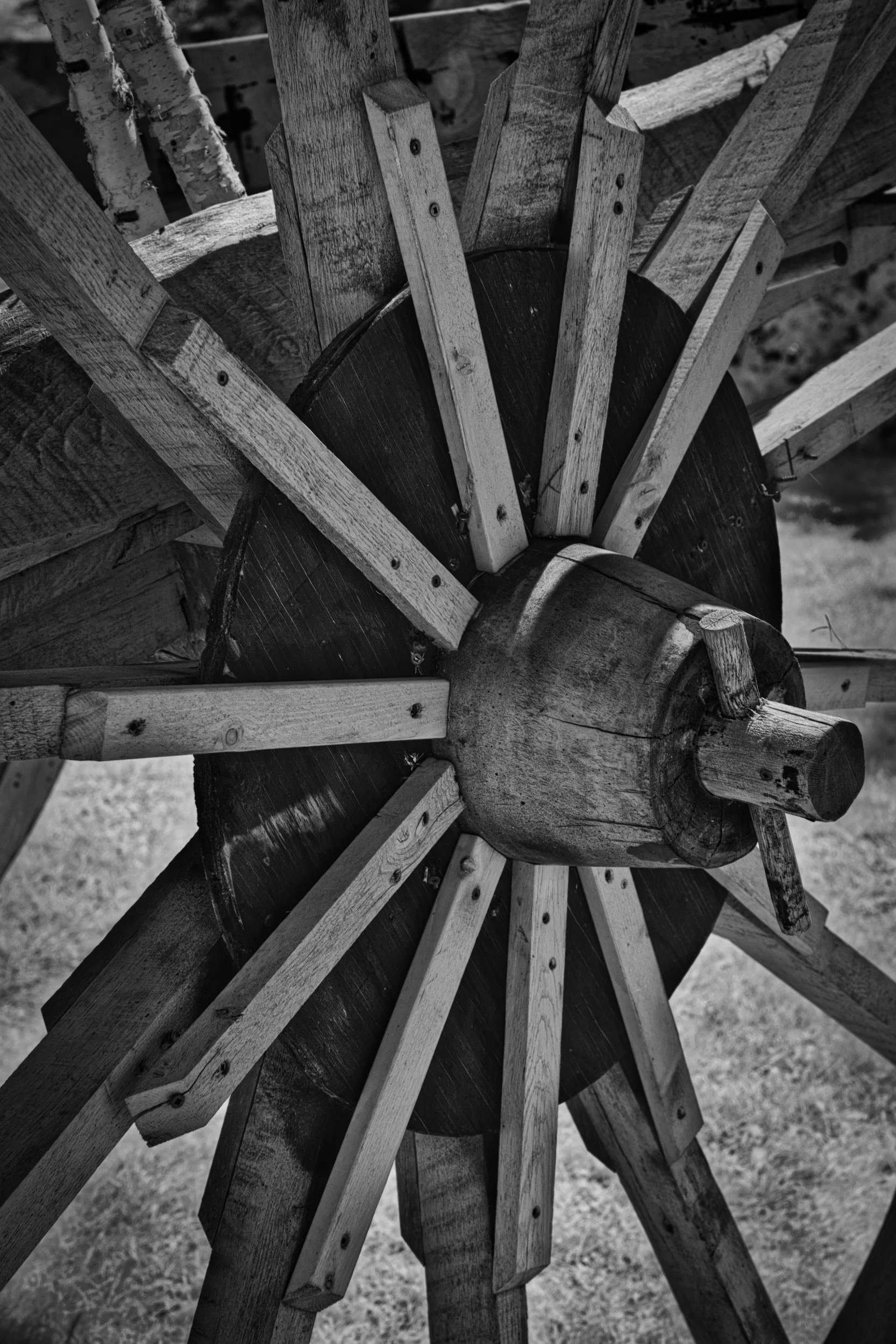 Close-up of a wooden geometric sculpture with interlocking wooden pieces, in black and white.