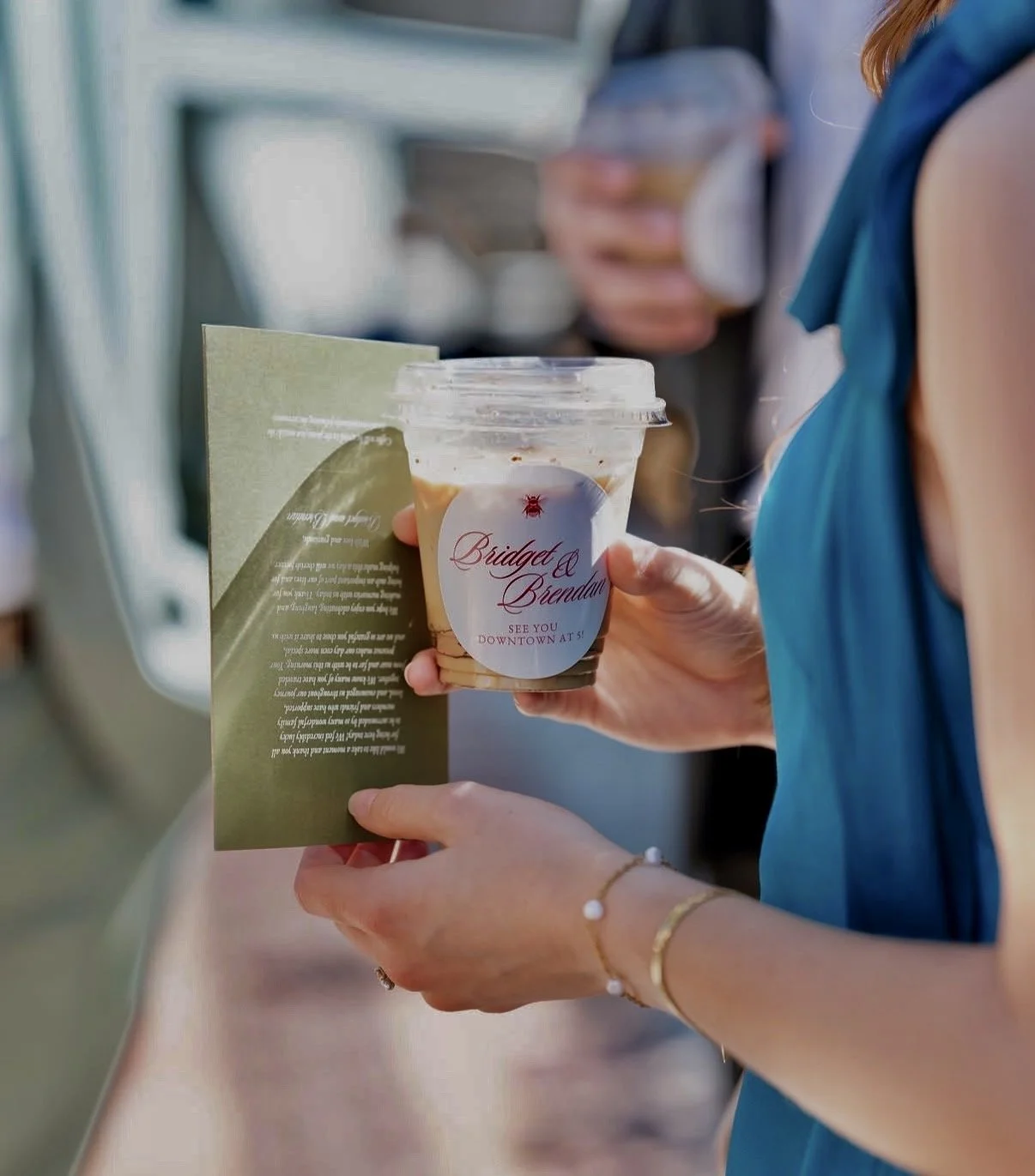 Wedding guest holding a personalized iced latte served by The Usual Coffee Co.