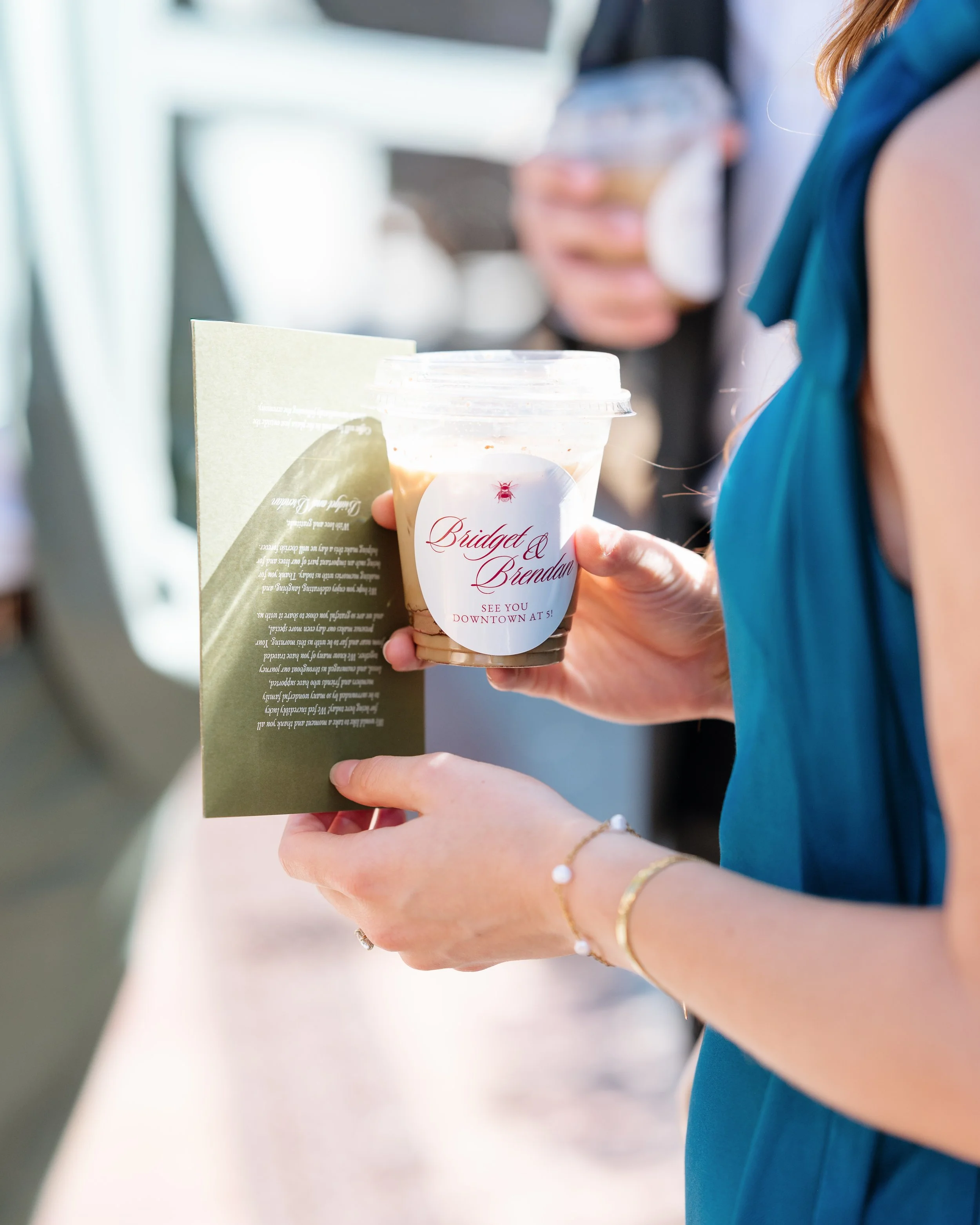 An iced latte in a personalized cup, freshly served to an event guest.