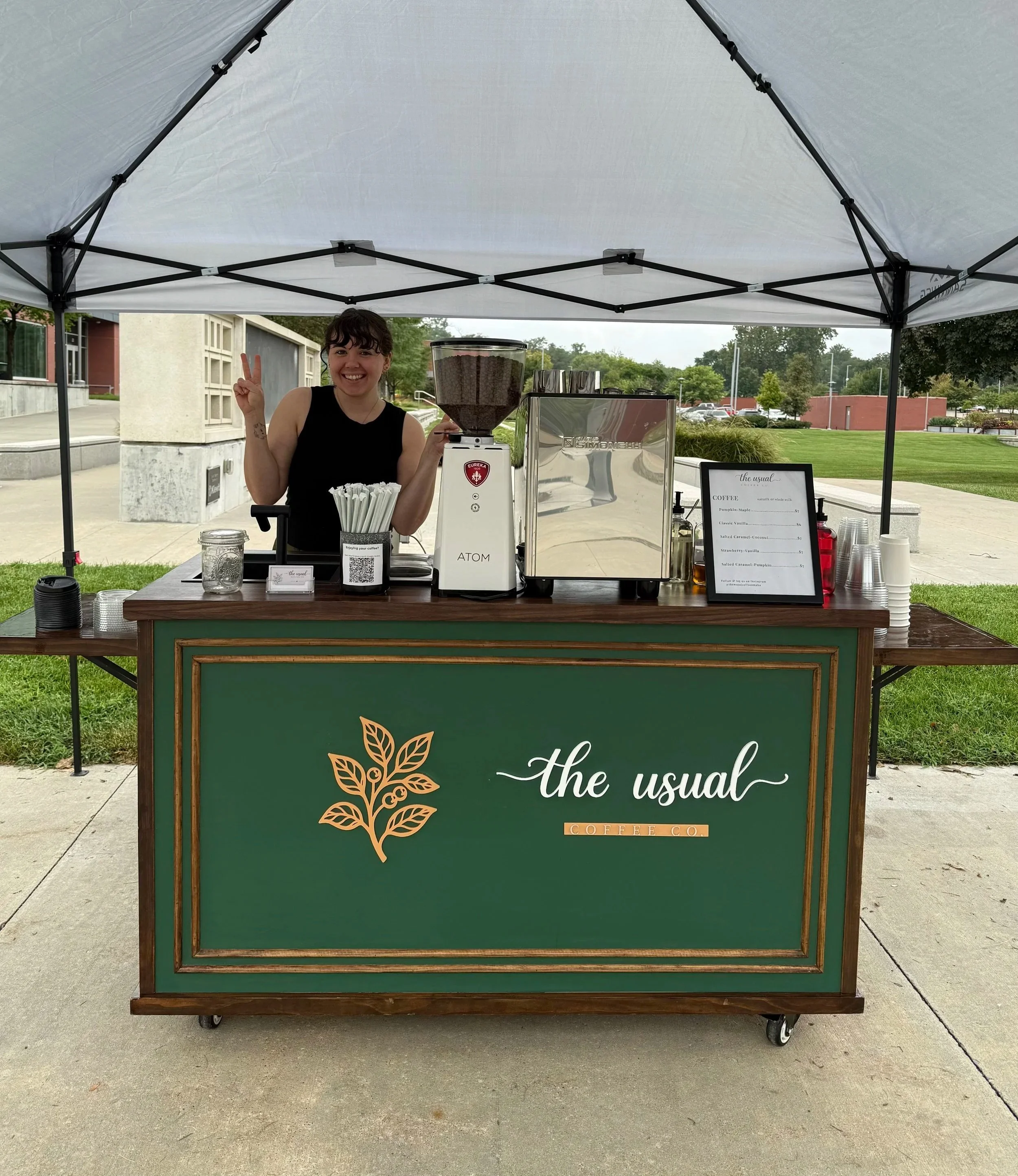 The Usual Coffee Co. coffee cart and a barista at a Metropolitan Community College event.