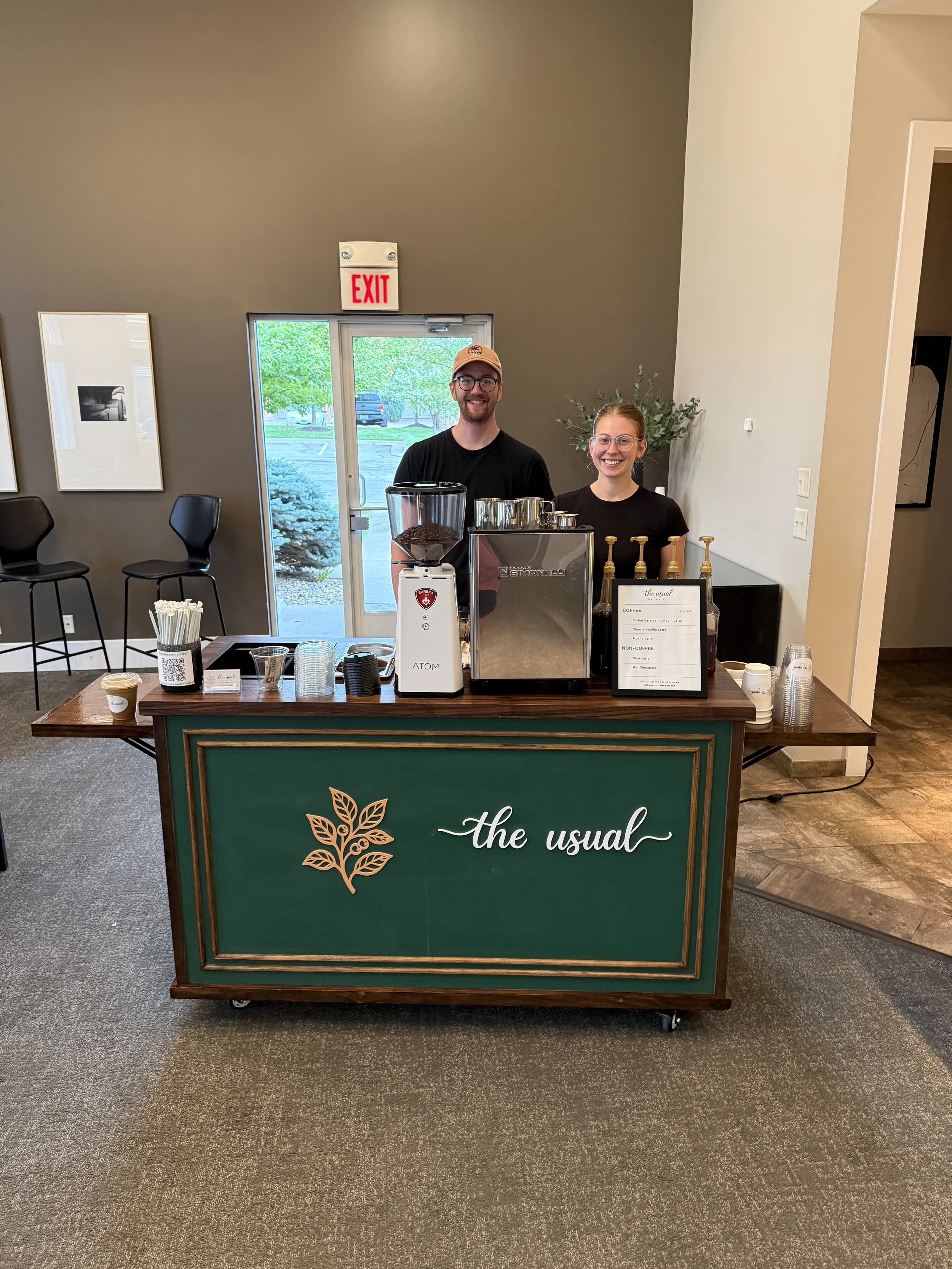 The Usual Coffee Co. baristas and green mobile espresso cart at an Omaha event
