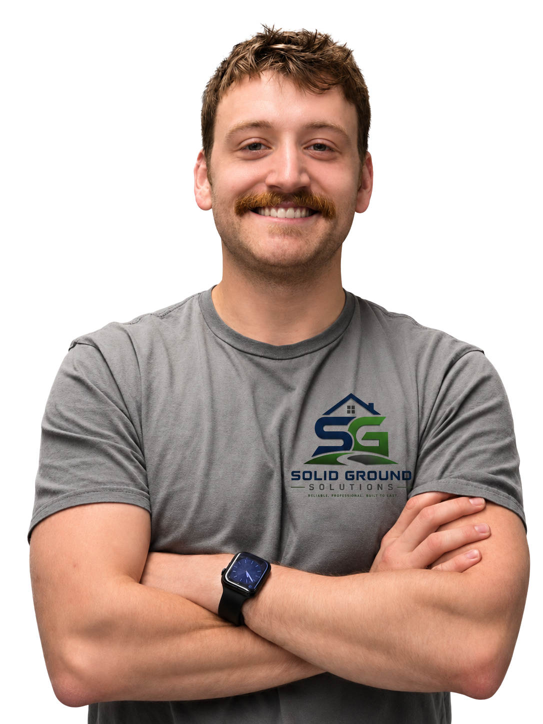 A man with short brown hair, a mustache, and beard smiling with arms crossed, wearing a gray t-shirt with a 'Solid Ground Solutions' logo and a black smartwatch.