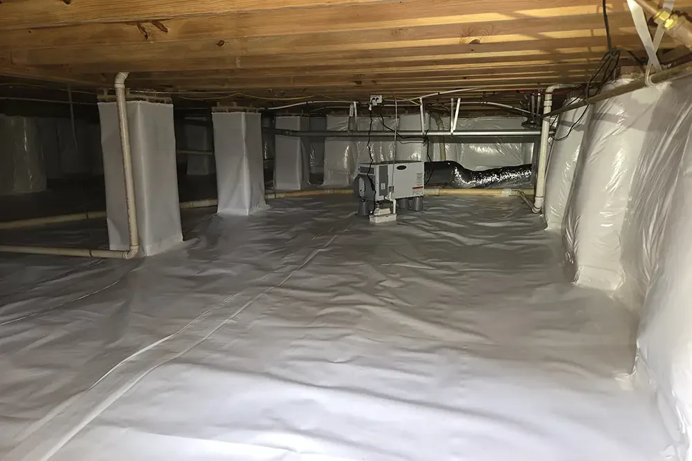 Crawlspace space with insulation and HVAC ductwork
