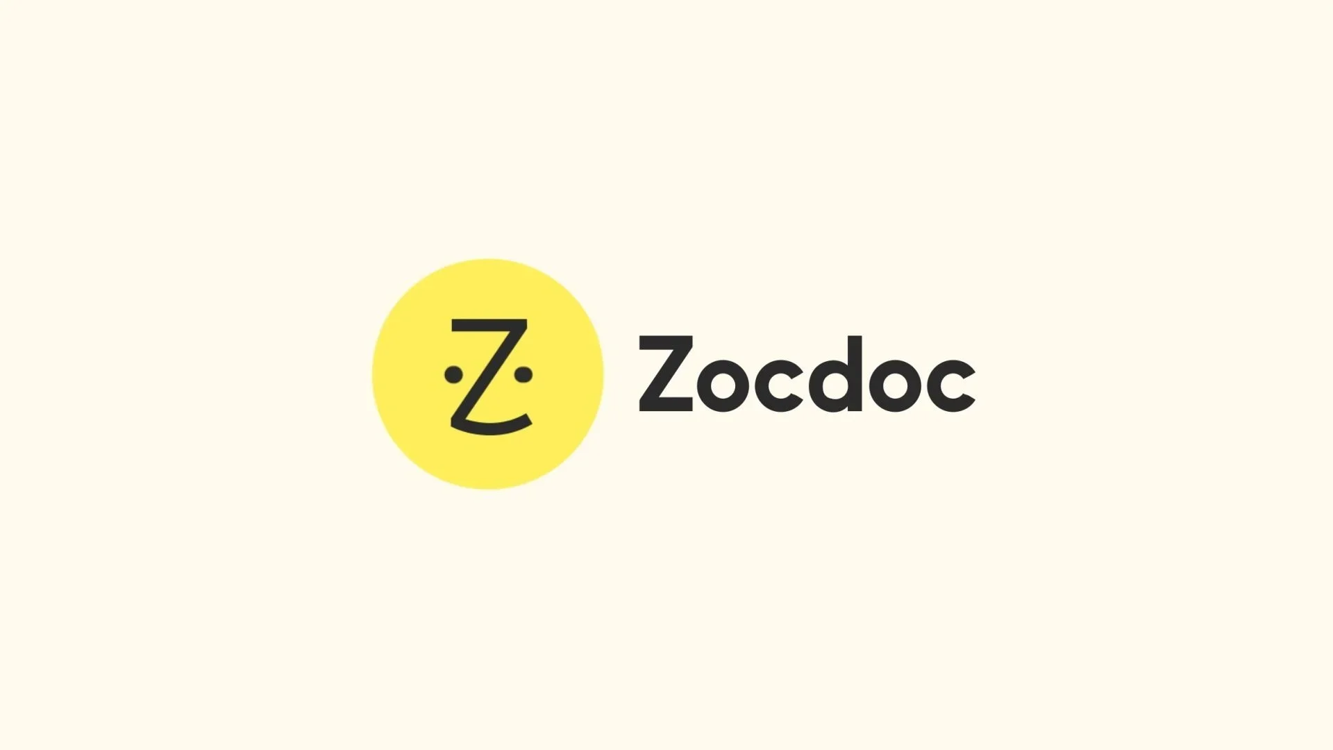Zocdoc logo featuring a yellow circle with a stylized black 'Z' and a face with two dots for eyes and a curved line for a mouth, beside the black text 'Zocdoc' on a light background.
