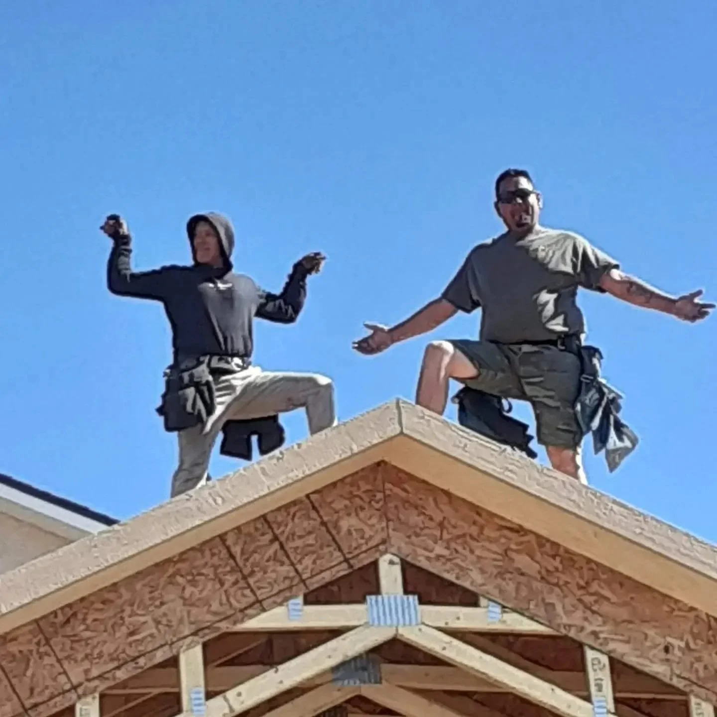 Pursuit of Excellence construction crew working on the roof framing of a building under construction.
