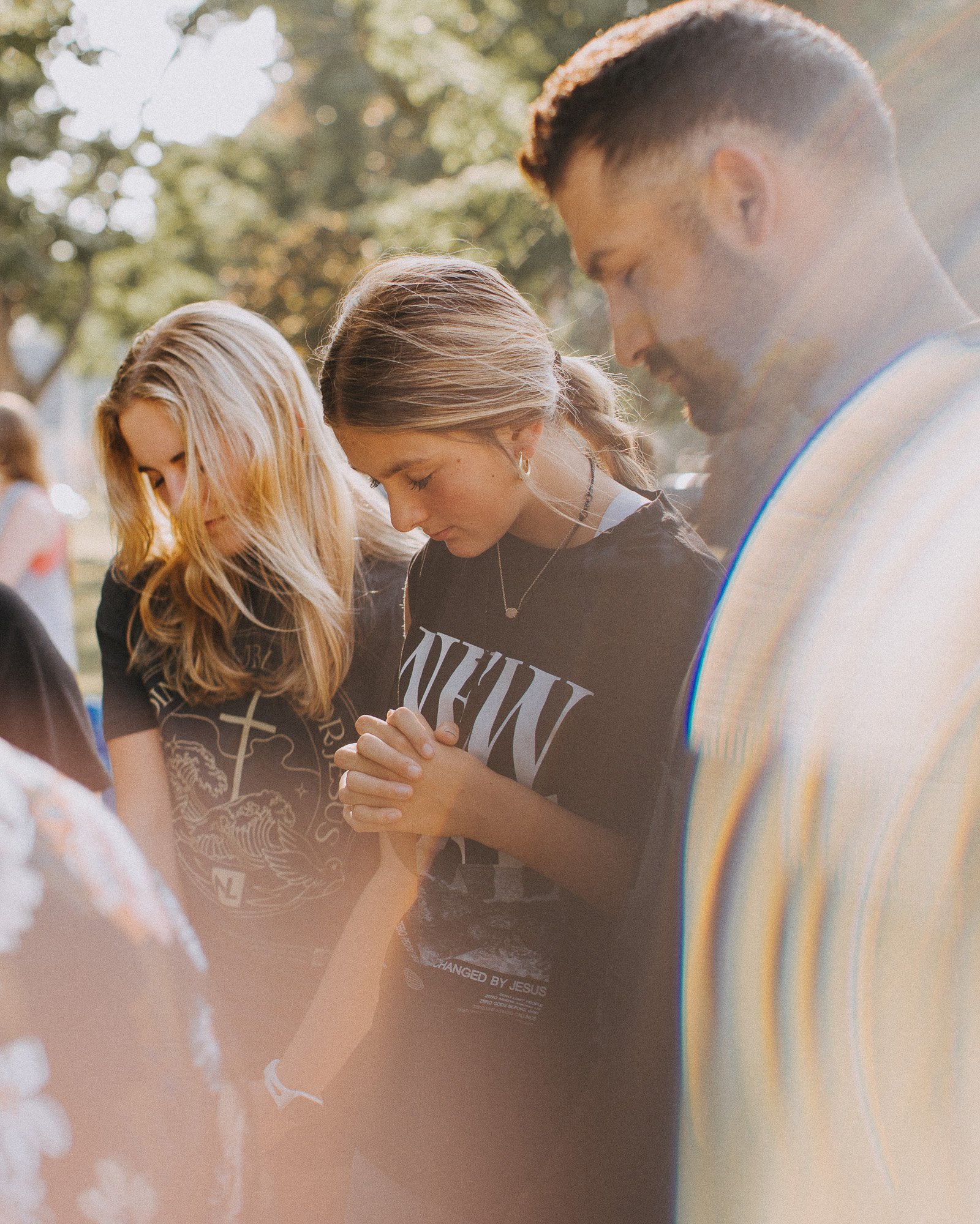 People praying together before a baptism at New Life Church