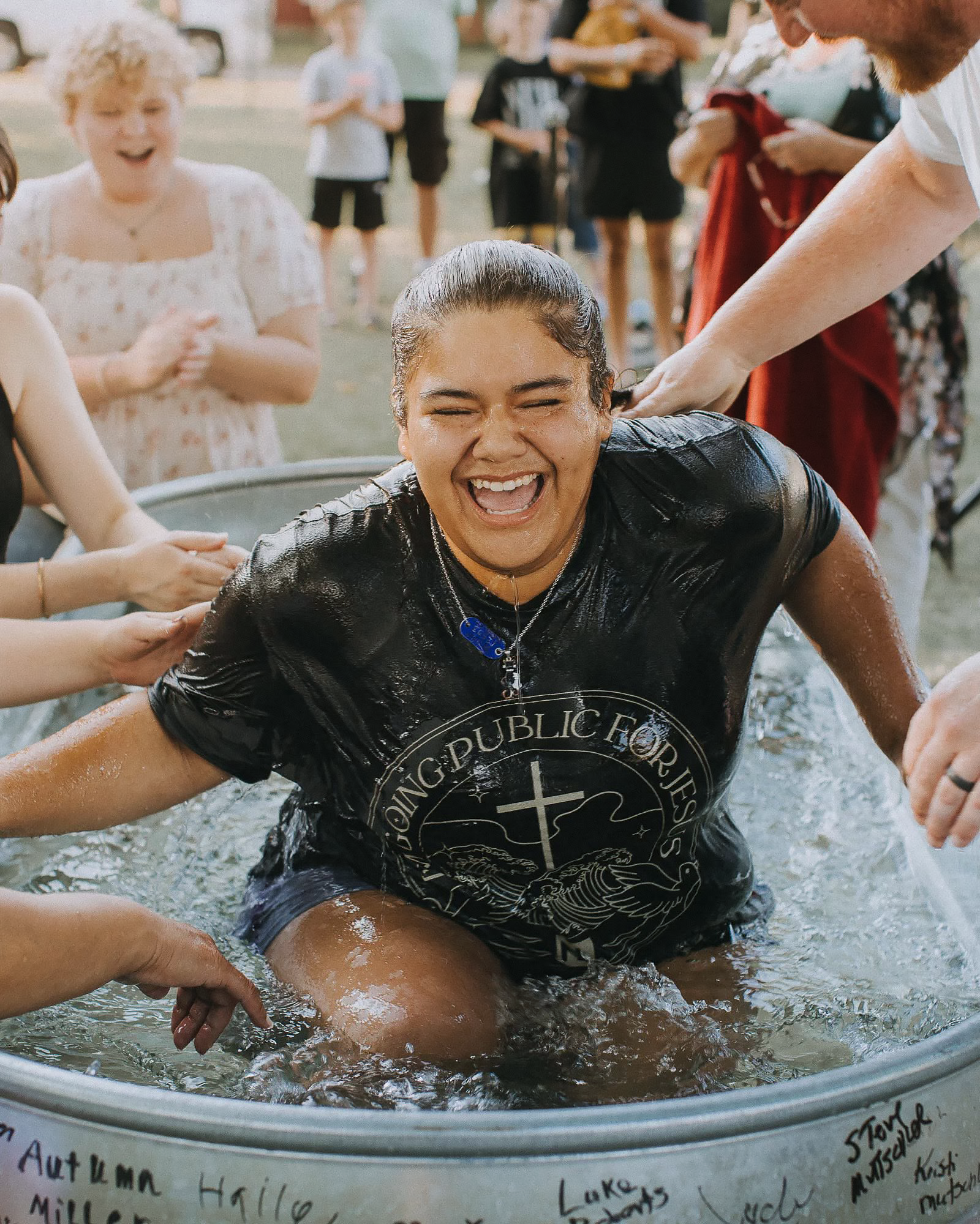 A woman celebrating after being baptized at New Life Church